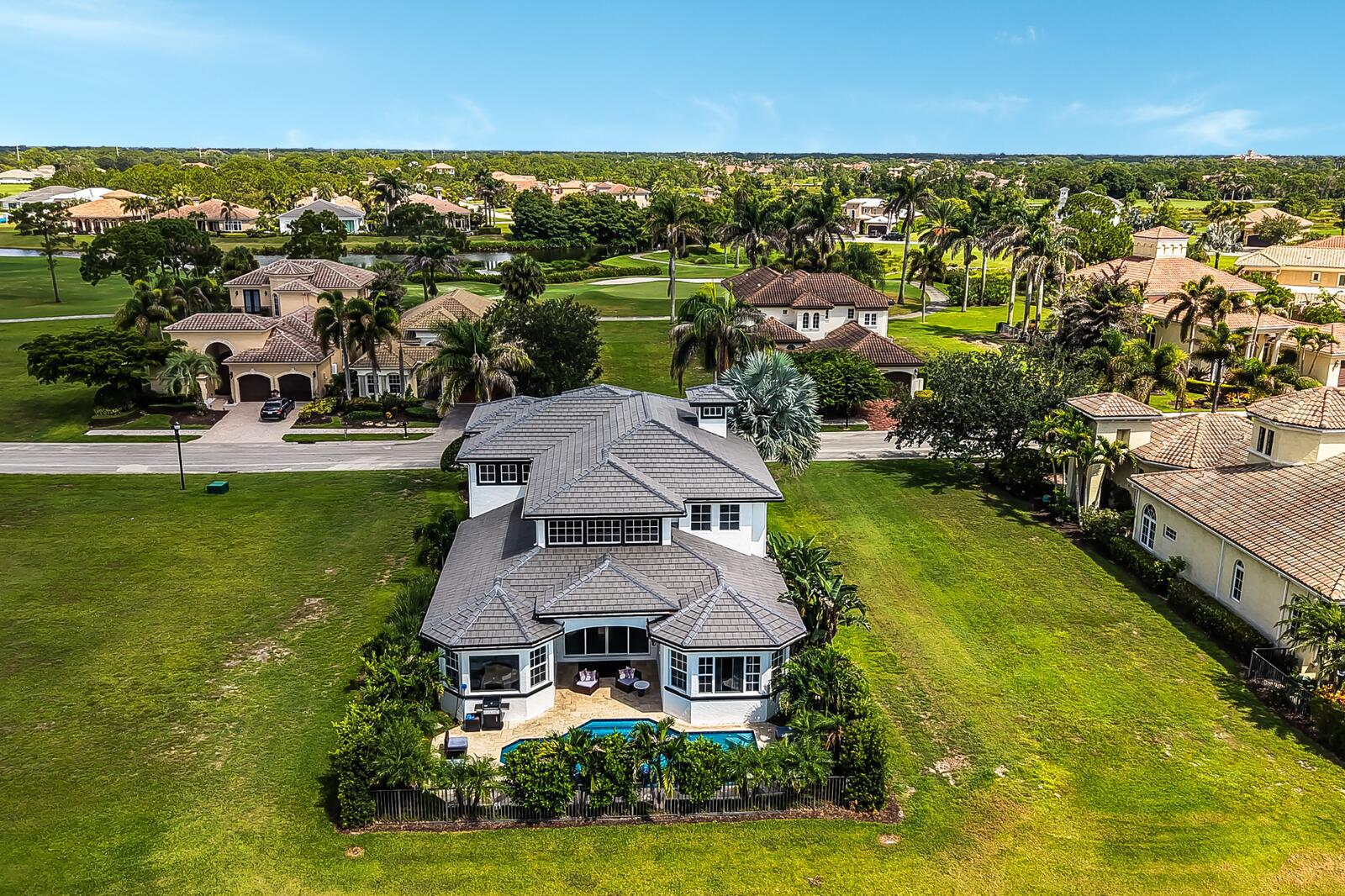 Two-story residence with a gray tile roof and white exterior siding