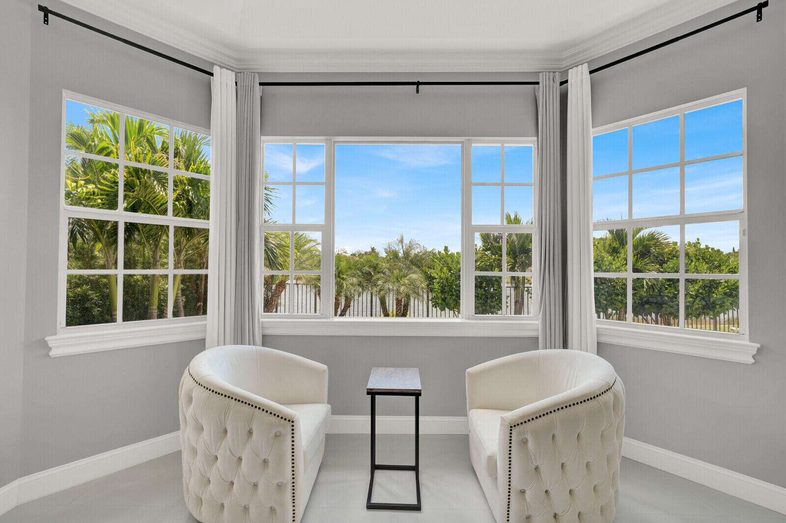 Bay window with multiple large grid windows, white trim, and light gray walls