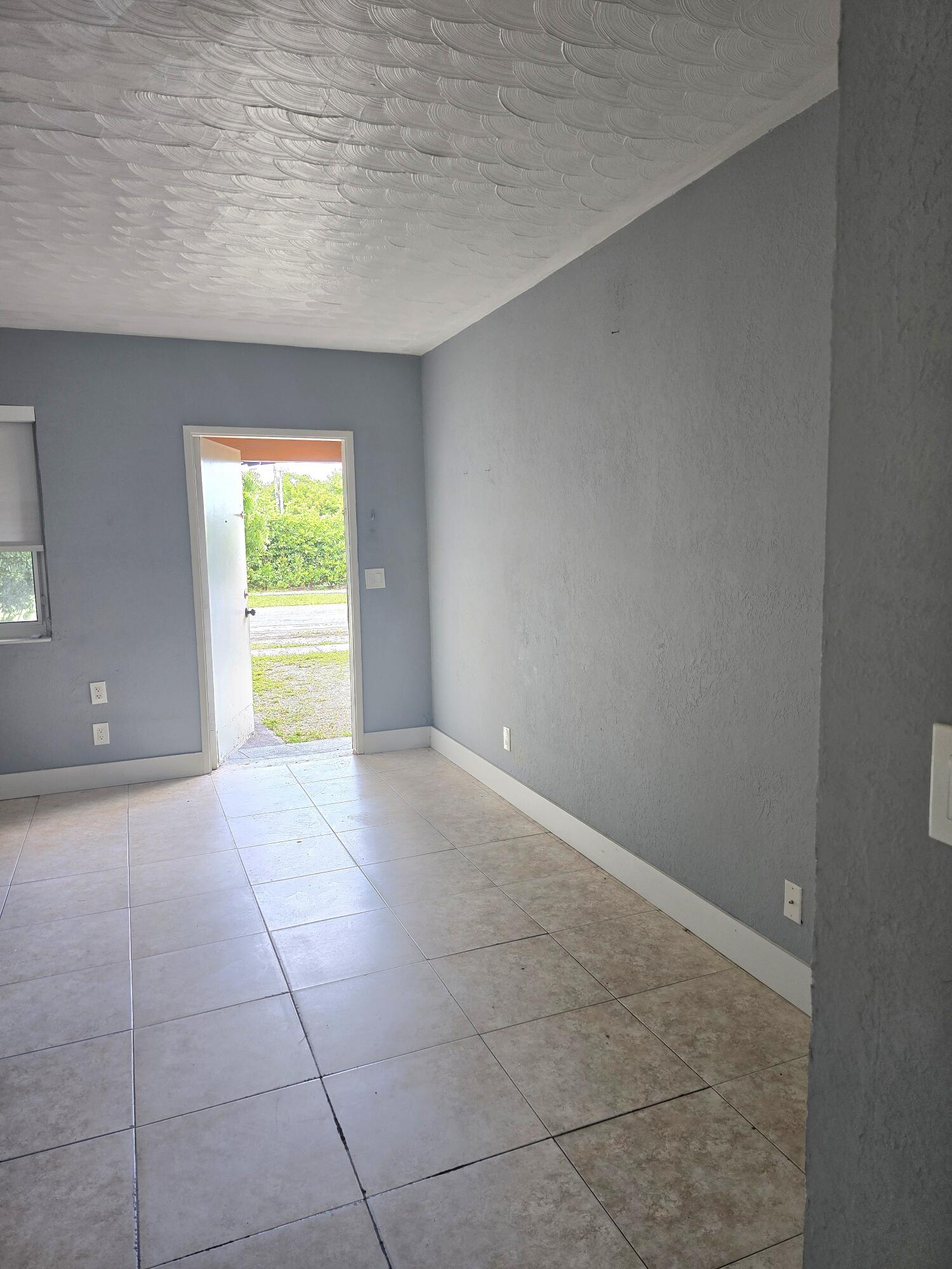 LIVING ROOM LOOKING TOWARDS FRONT DOOR