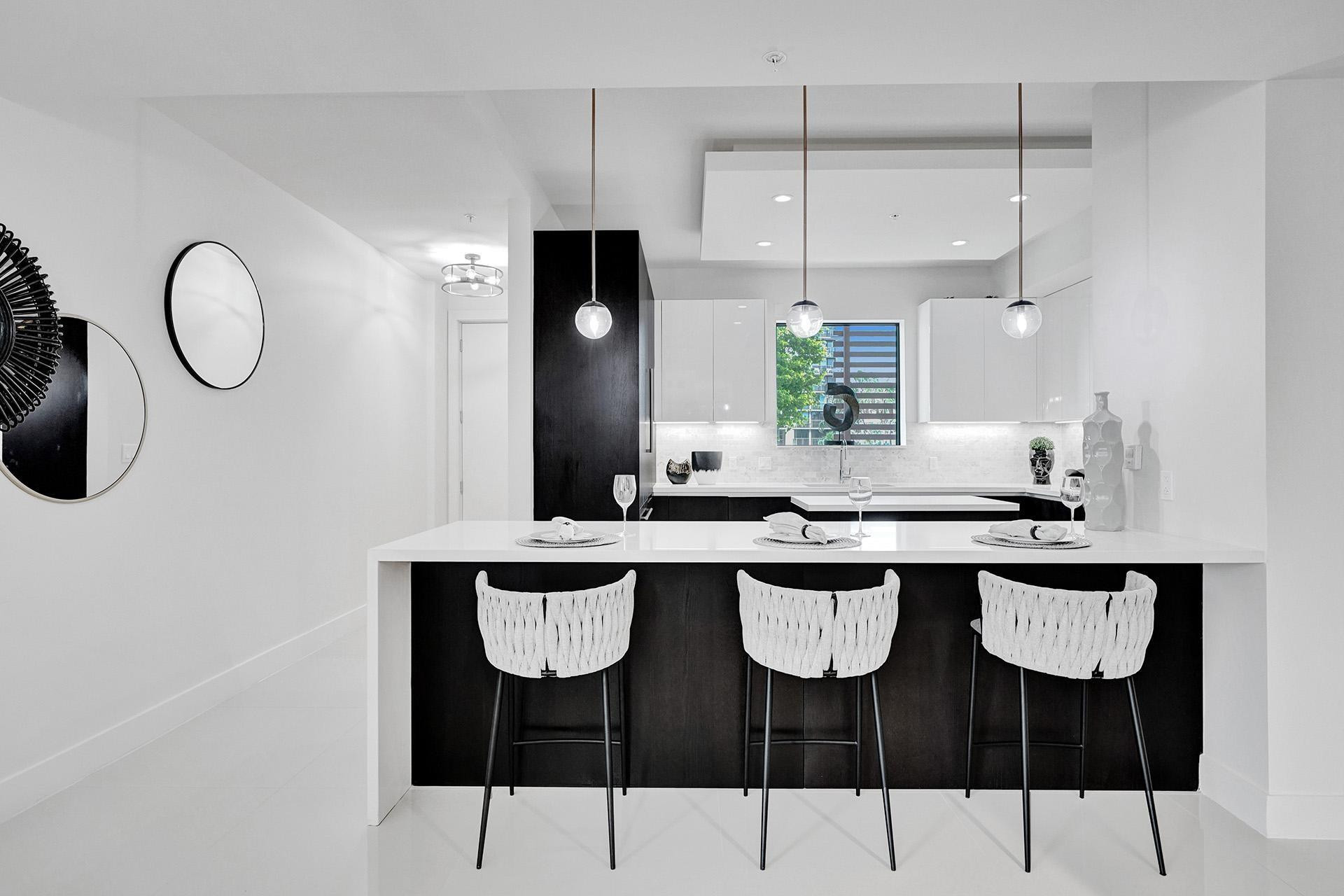Modern kitchen with a white countertop island and dark wood-finish base cabinetry