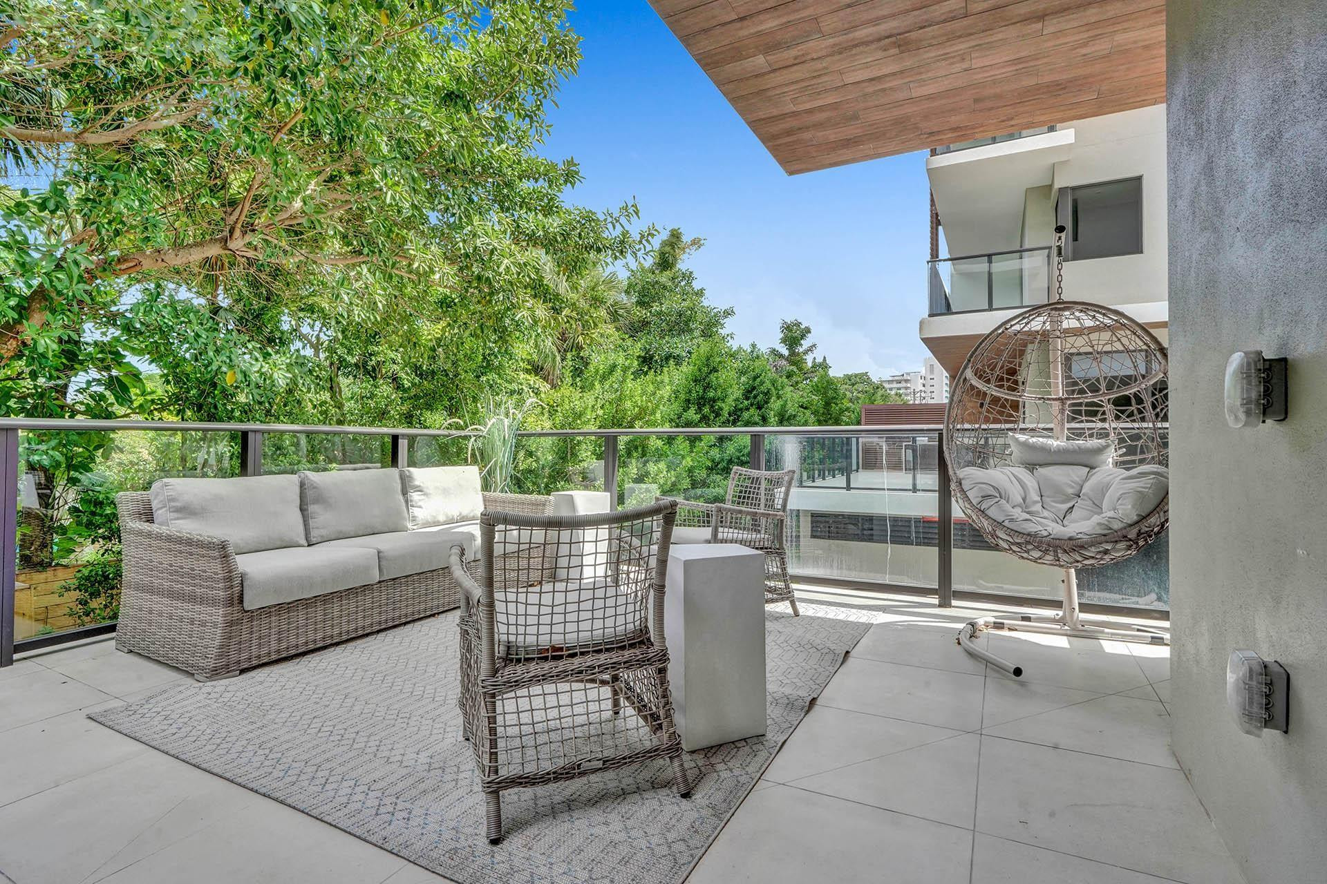 Spacious outdoor balcony featuring tile flooring and glass railings