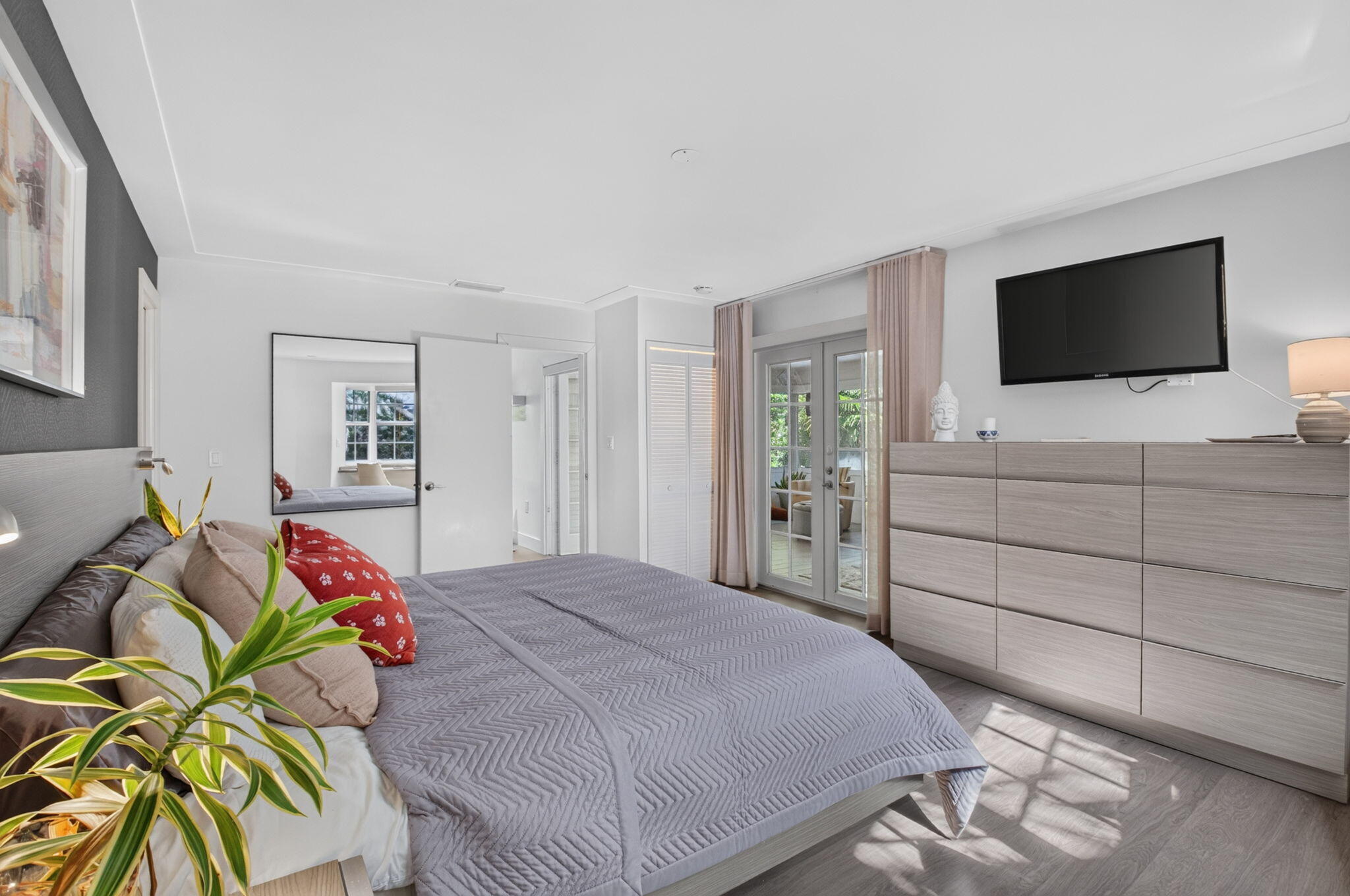 PRIMARY BEDROOM HAS FRENCH DOORS LEADING TO THE SUNROOM....