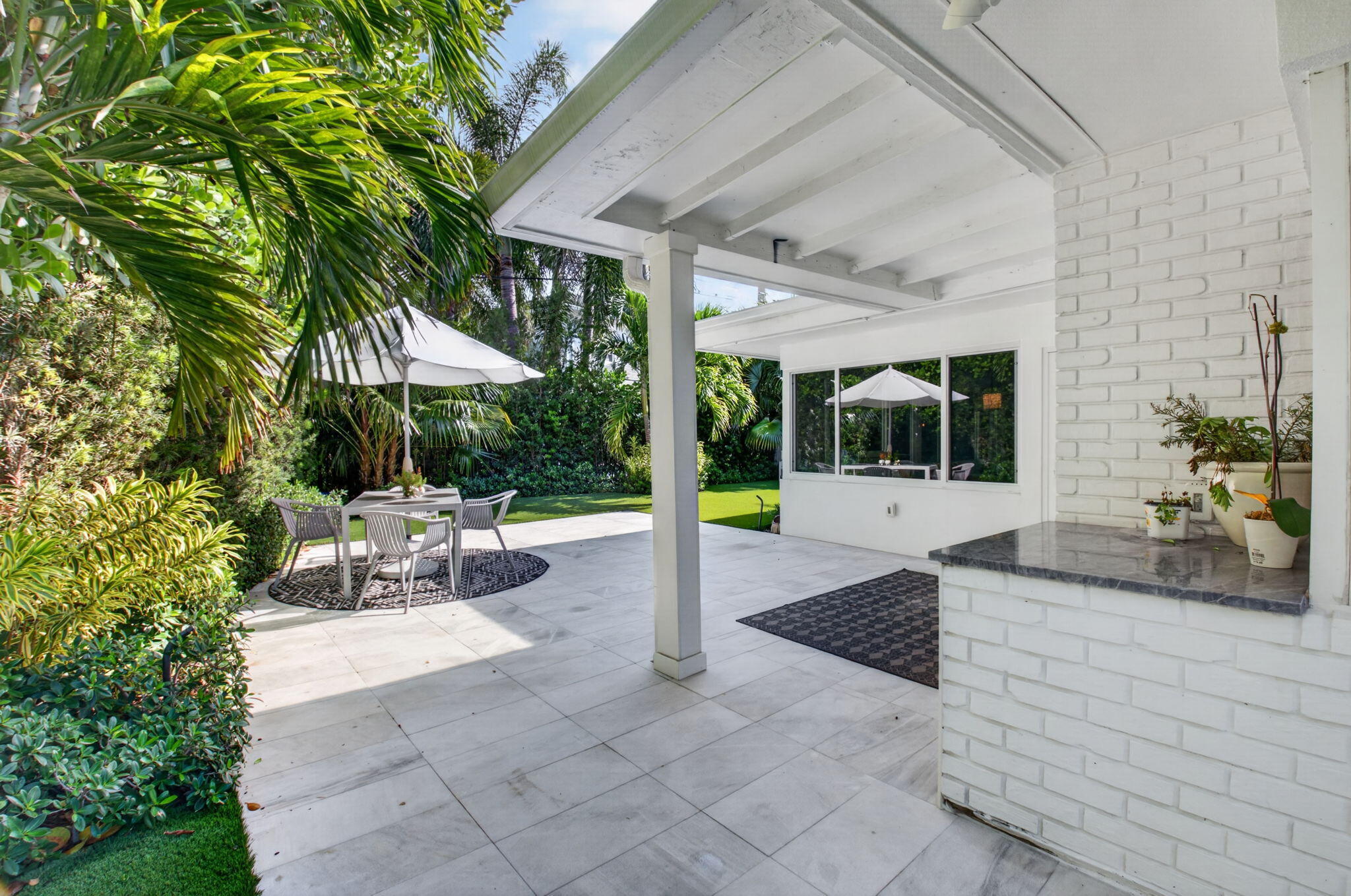 THE COVERED AREA ON THE PATIO IS THE PERFECT SIZE FOR DINING IN ON RAINY DAYS.