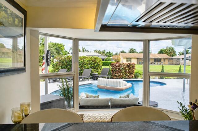 Pool view From Kitchen Bay Window. Enjoy beautiful pool and backyard views right from your kitchen, bringing the outdoors into everyday living.