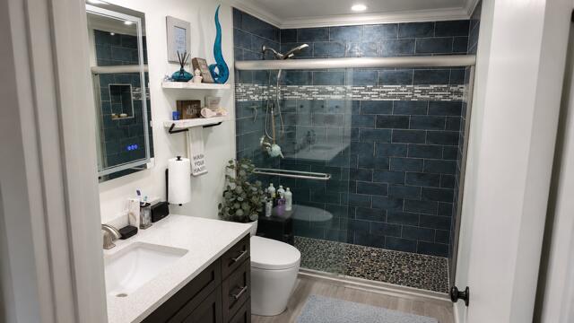 This beautiful renovated primary bathroom features a striking walk-in shower with rich color tile work, pebble- stone flooring, smart toilet with heated seat, and sleek modern finishes.