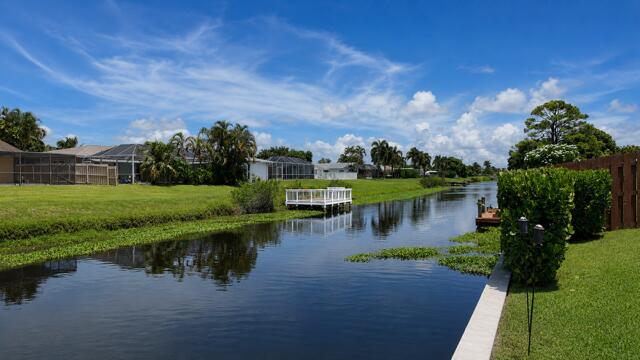 Enjoy long, peaceful canal views directly from the property's seawall, creating a serene waterfront backdrop. This navigable freshwater canal is ideal for Kayaking, fishing, and embracing the relaxed yet fun waterfront lifestyle.