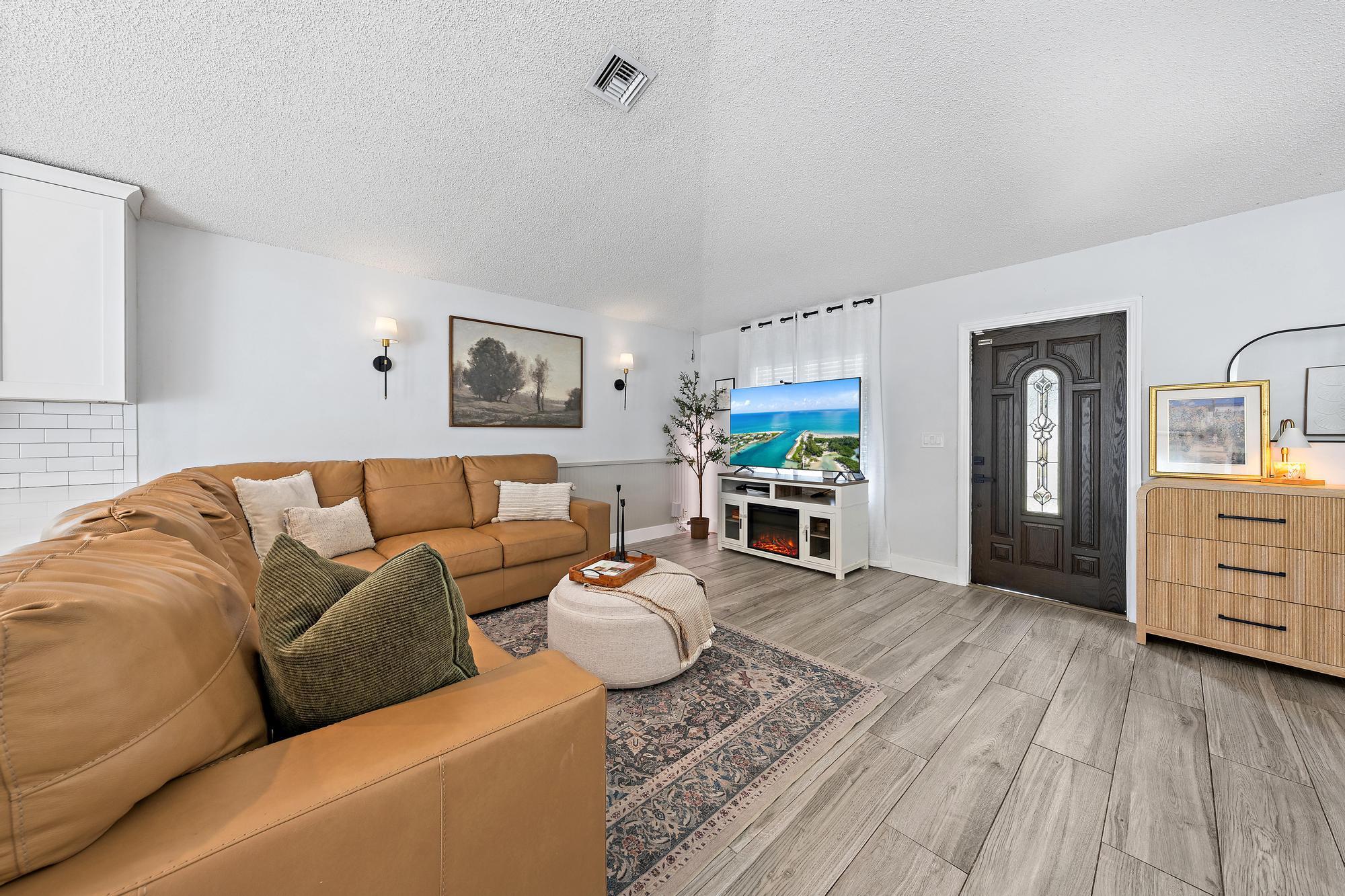 Wood-finish flooring throughout, white walls, and built-in wall sconces
