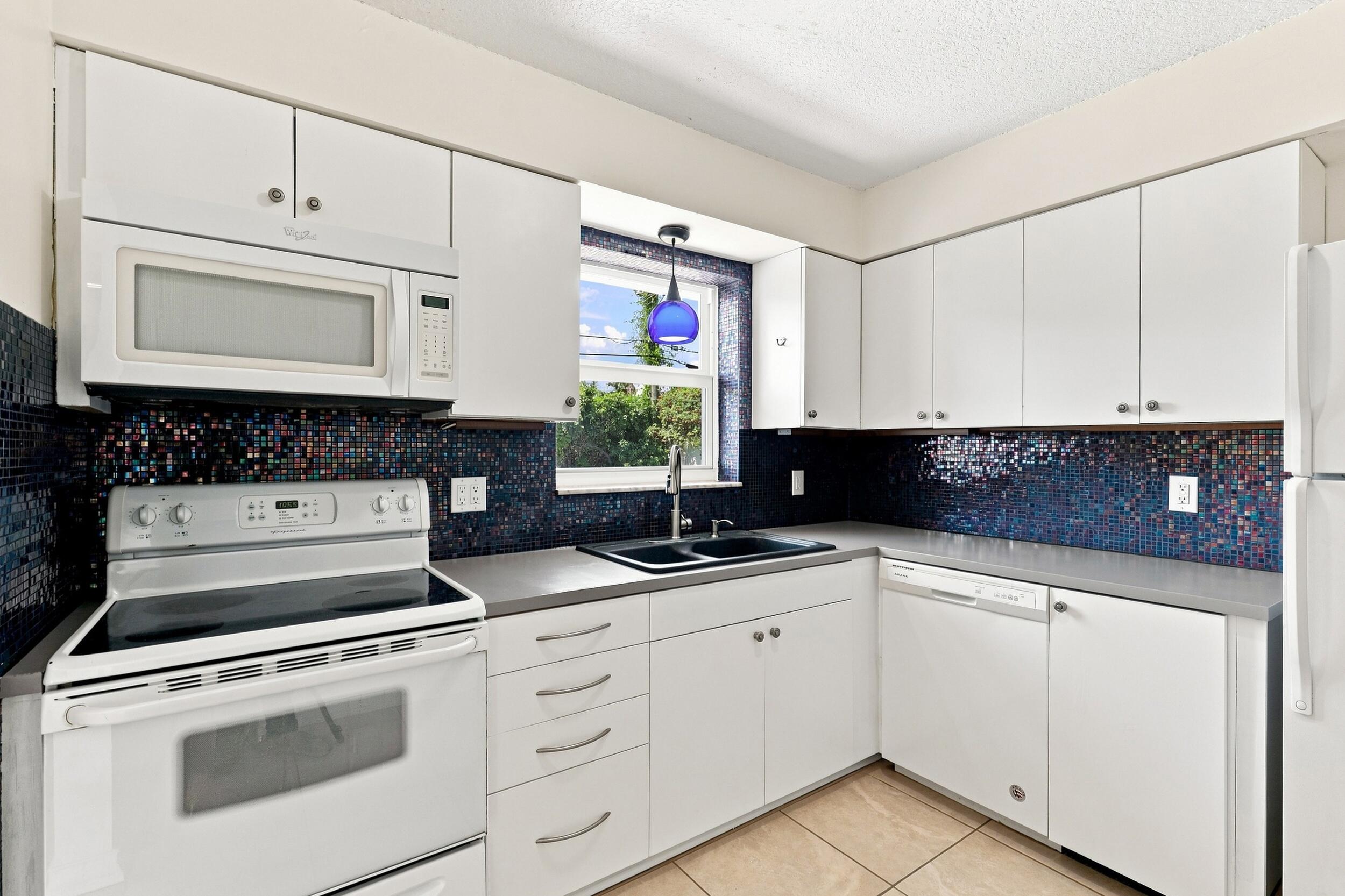Additional kitchen view highlighting the cabinetry, counter space, and appliances.