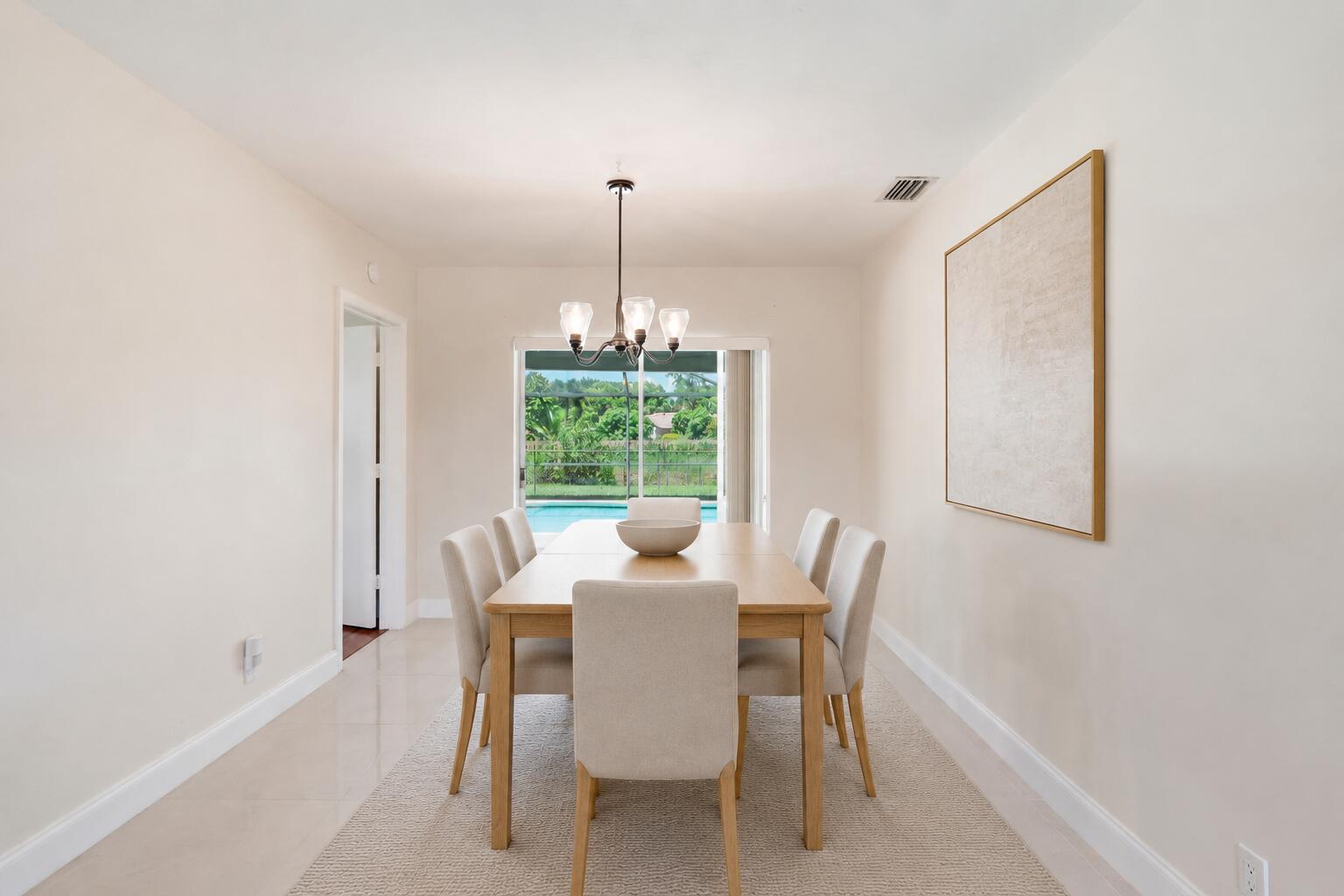 Dining Room with access to patio/pool. (virtually staged for illustrative purposes; no permanent features or finishes have been altered) Dining Room with access to patio/pool. (virtually staged for illustrative purposes; no permanent features or finishes have been altered)