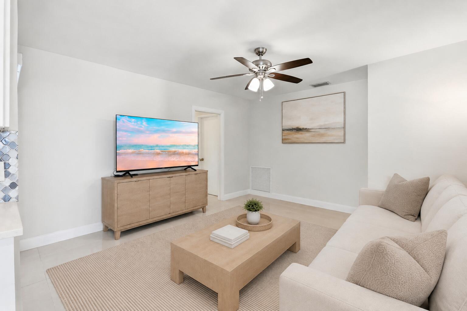 Family Room leads to cabana bath and two bedrooms. (virtually staged for illustrative purposes; no permanent features or finishes have been altered)
