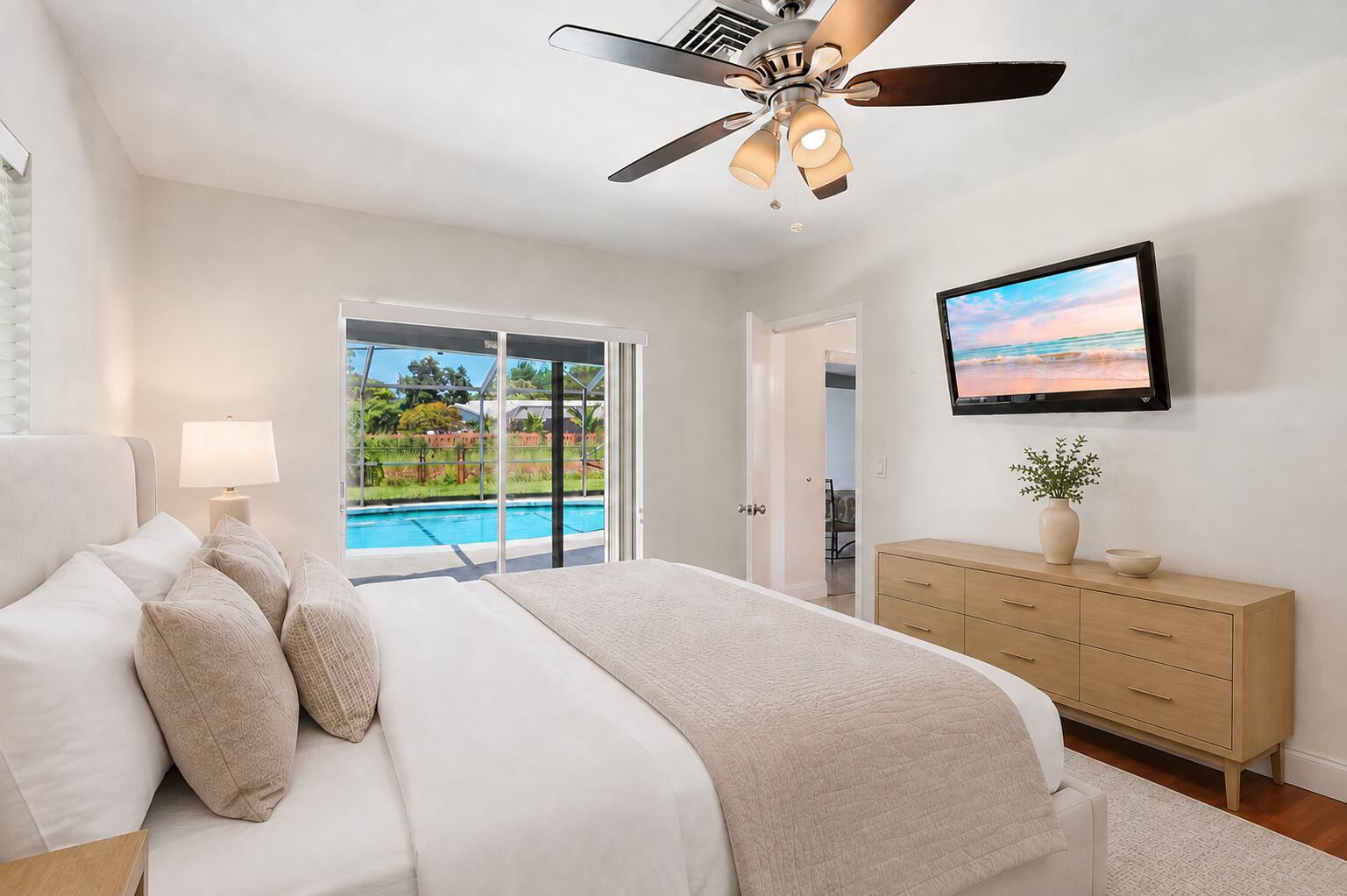 Primary bedroom has direct access to patio/pool. (virtually staged for illustrative purposes; no permanent features or finishes have been altered)