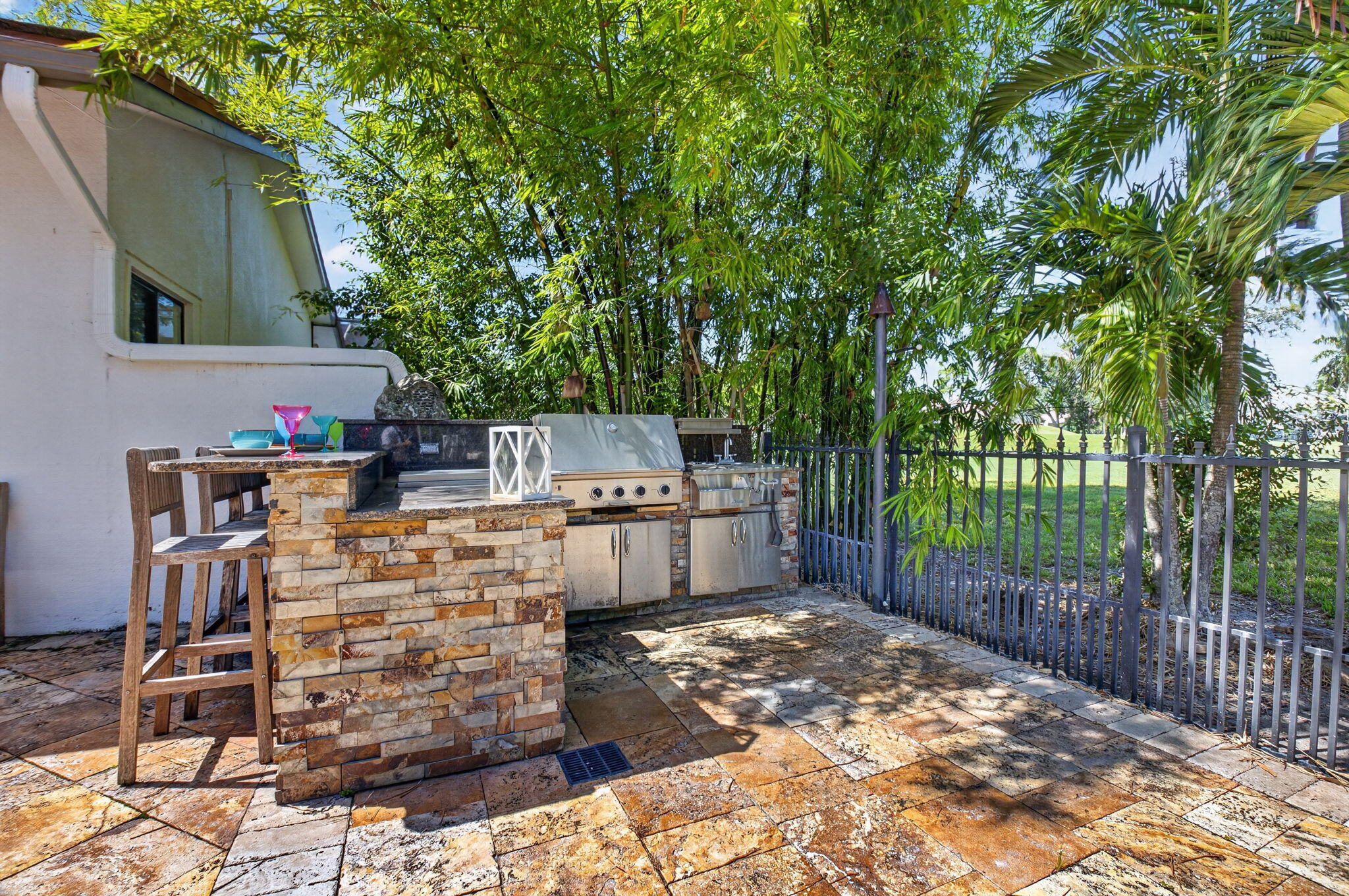 Grill out your burgers at the summer kitchen with wet bar and refrigerator.
