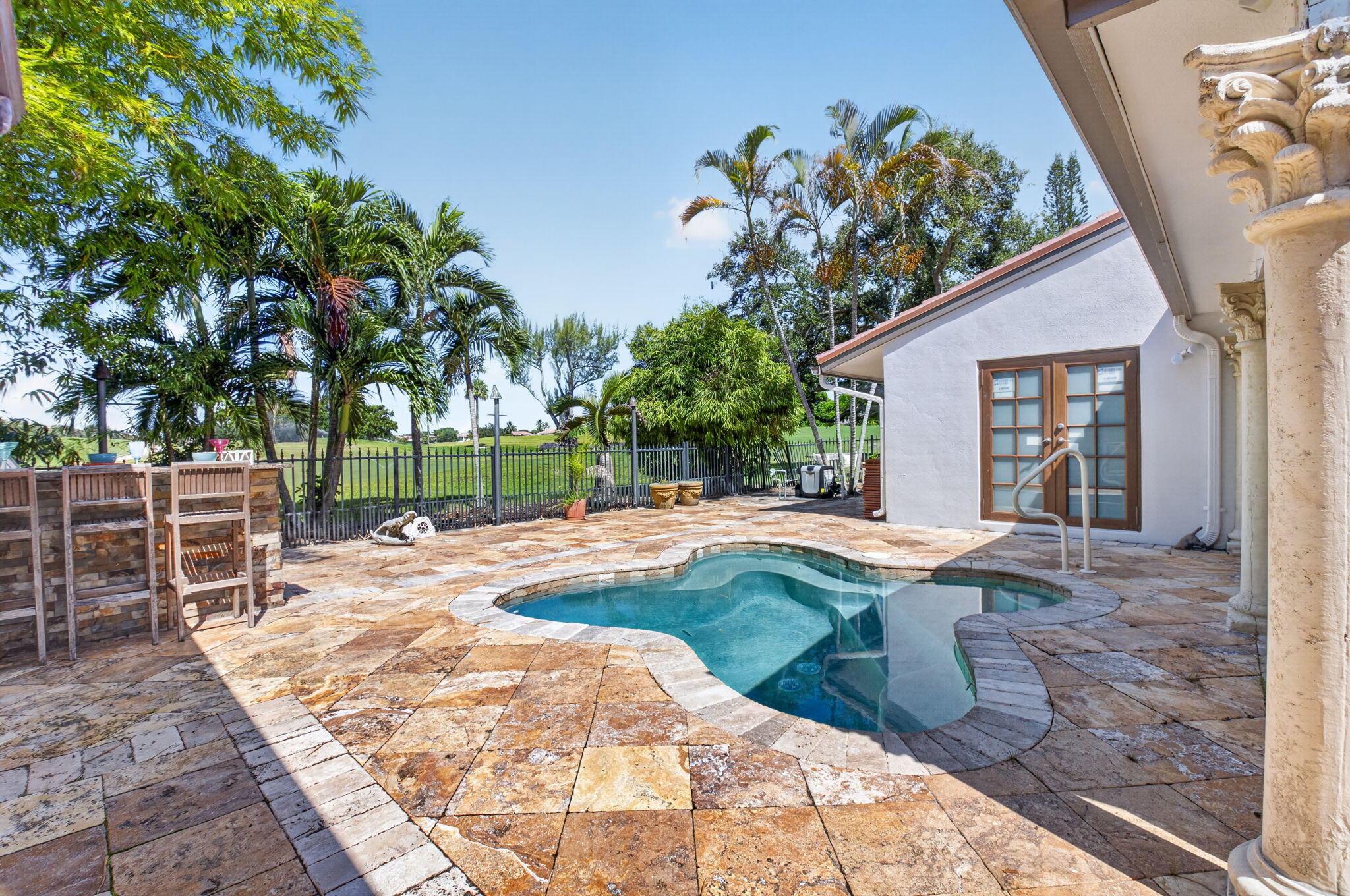 Pool patio and summer kitchenoverlooking the manicured greens. Party like a rock star.