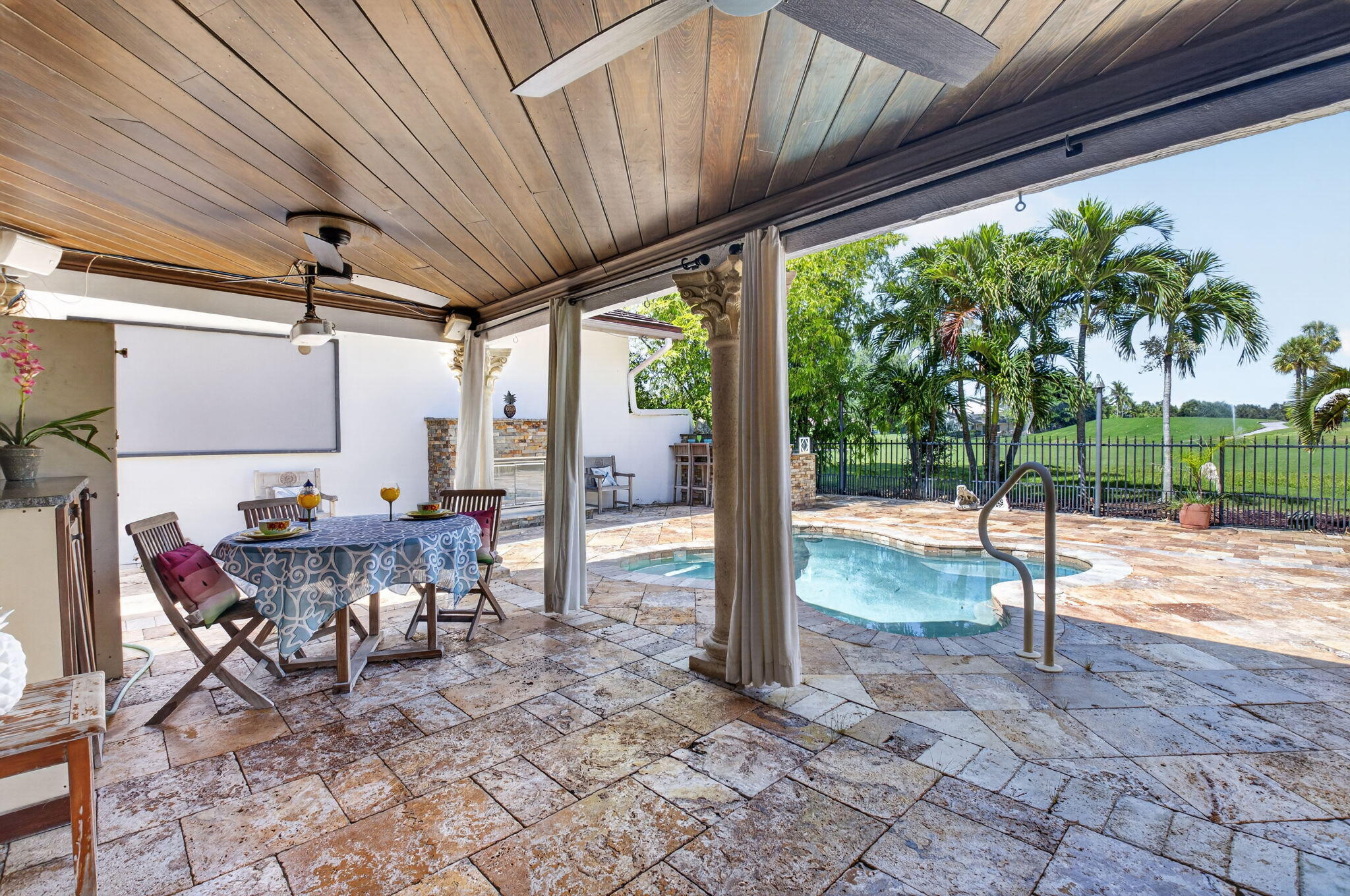 Relax with guests on your oversized travertine paver patio. 20x11' covered patio with beadboard ceiling.