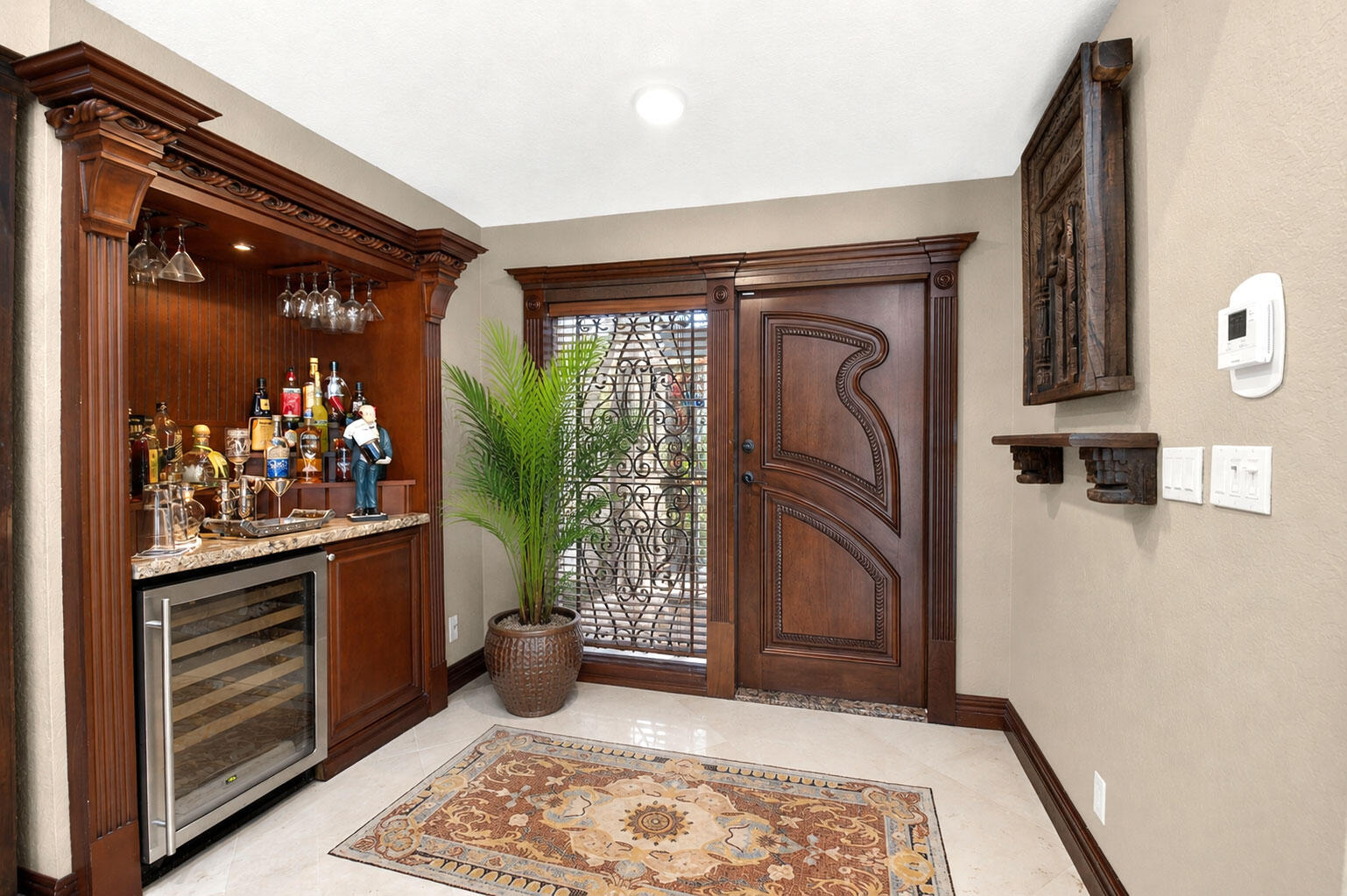 Mosiac foyer entry equipped with a beautiful bar buildout. Mosiac foyer entry equipped with a beautiful bar buildout.