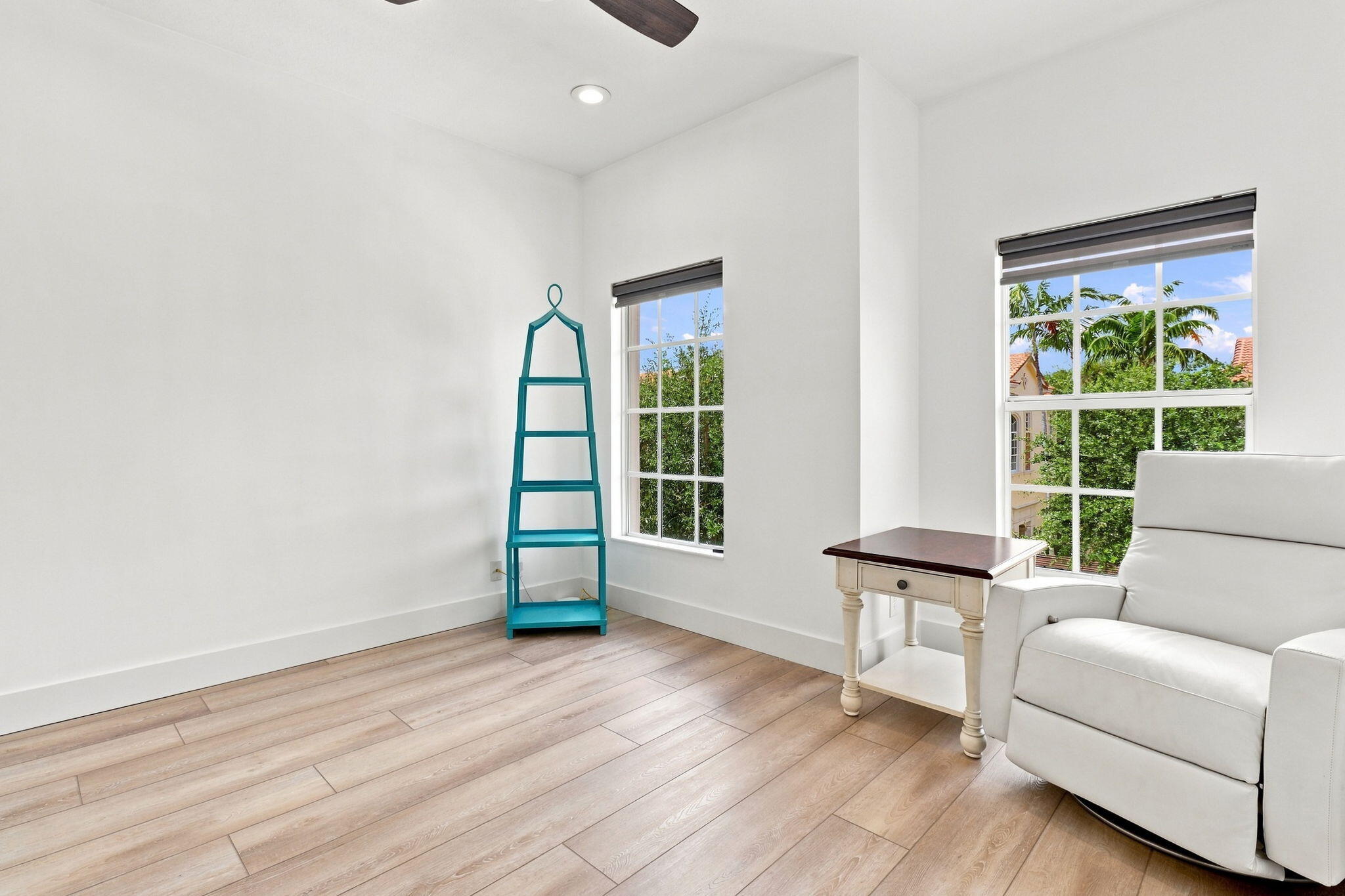 Recessed lighting, ceiling fan, luxury vinyl flooring and two windows with blinds