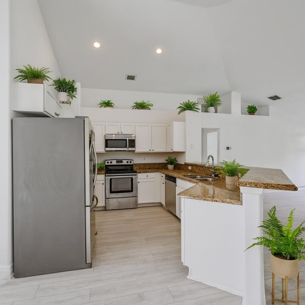 Spacious White Kitchen with Greenery