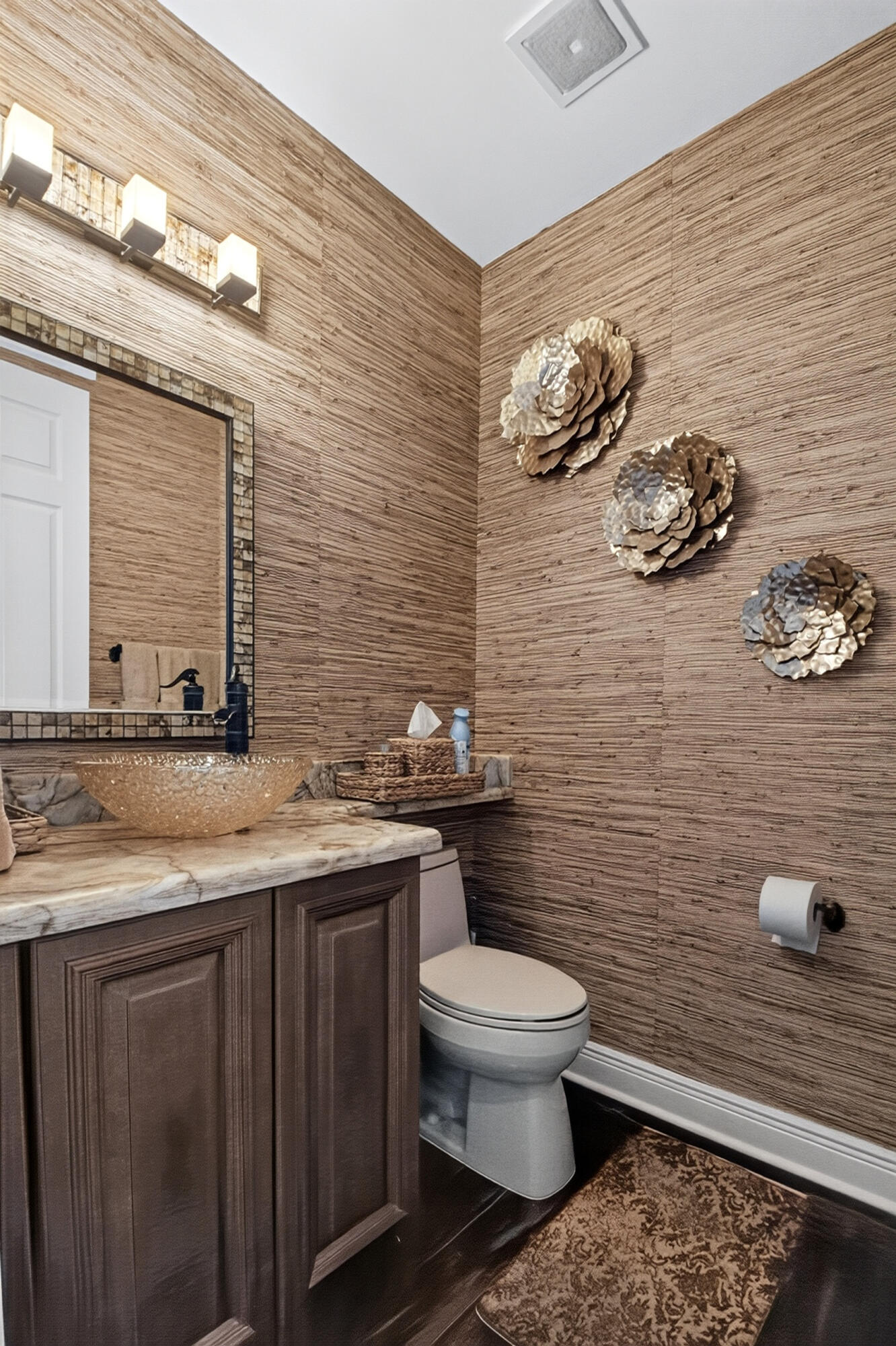 Luxurious Grasscloth Walls & an Onyx Counter which is really beautiful. Custom Mirror.
