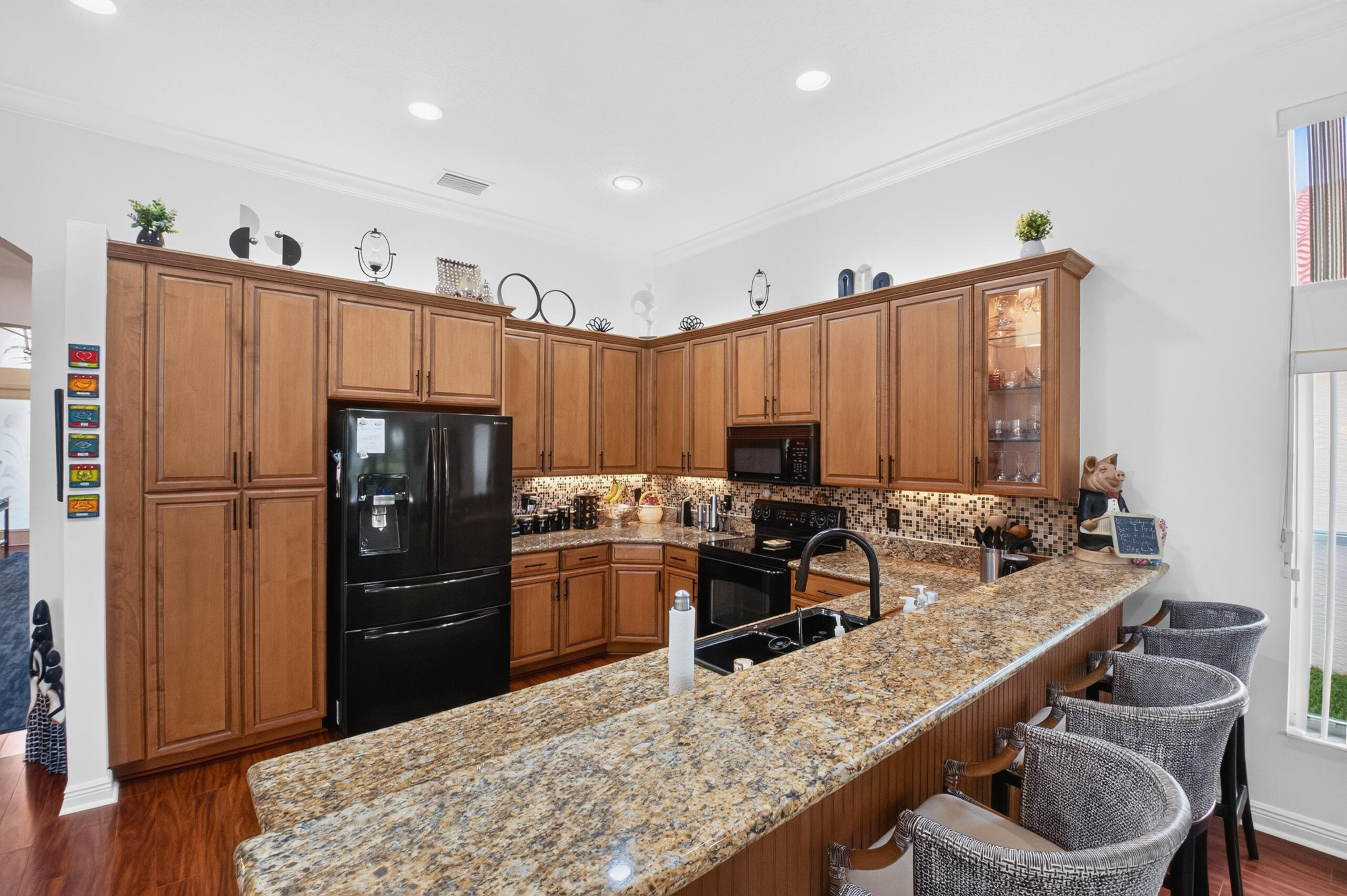 Elegant granite countertops & an attractive backsplash compliments the kitchen's sophisticated design.