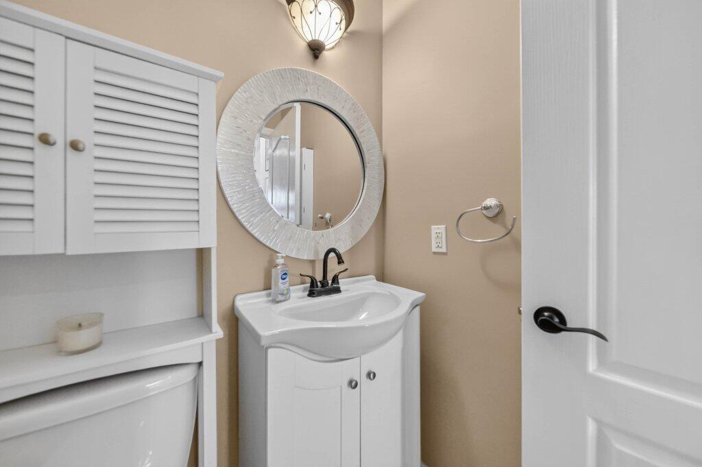 White vanity with integrated sink, oil-rubbed bronze faucet. Convenient for dinner guests!