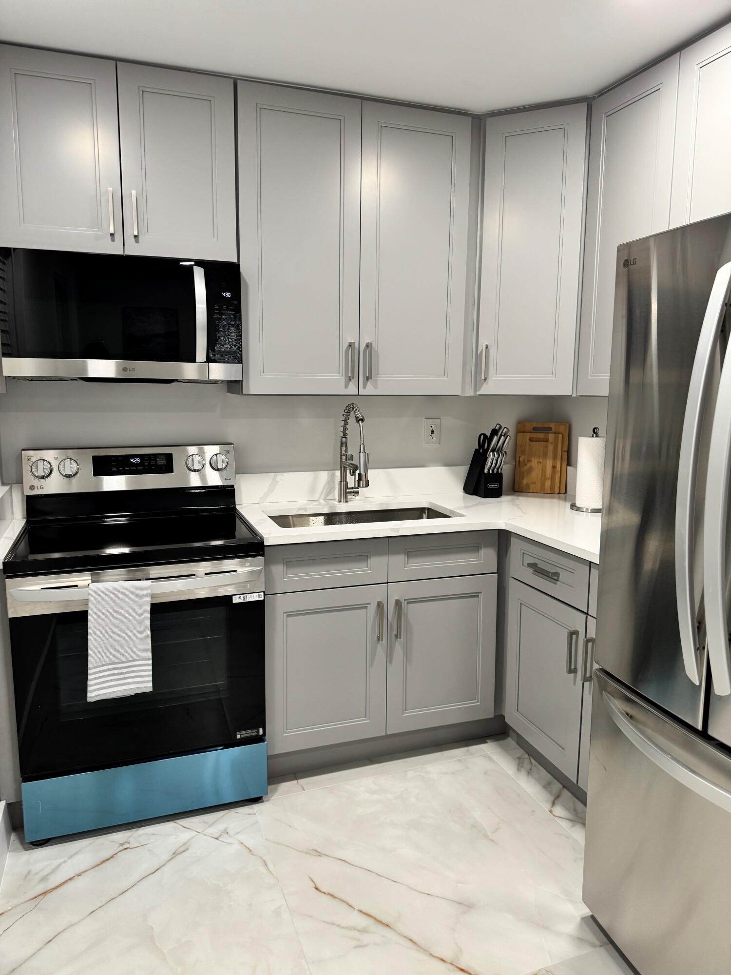 Updated kitchen with modern white cabinetry, sleek hardware, and a contemporary finish Updated kitchen with modern white cabinetry, sleek hardware, and a contemporary finish