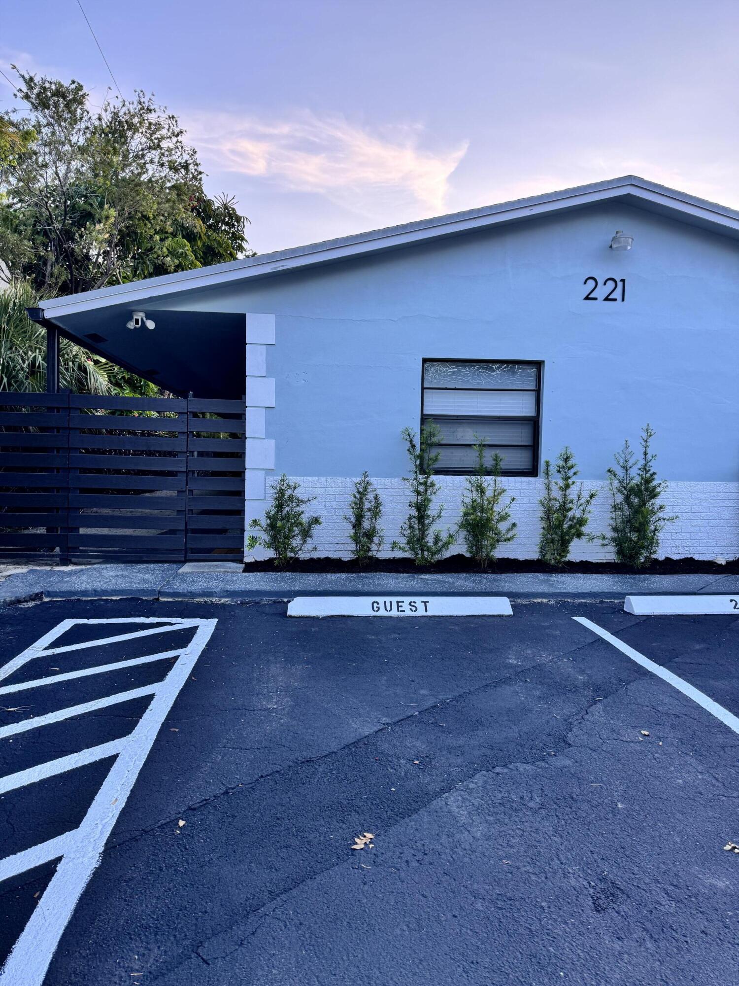Paved parking area with white line markings and "GUEST" parking space Paved parking area with white line markings and "GUEST" parking space