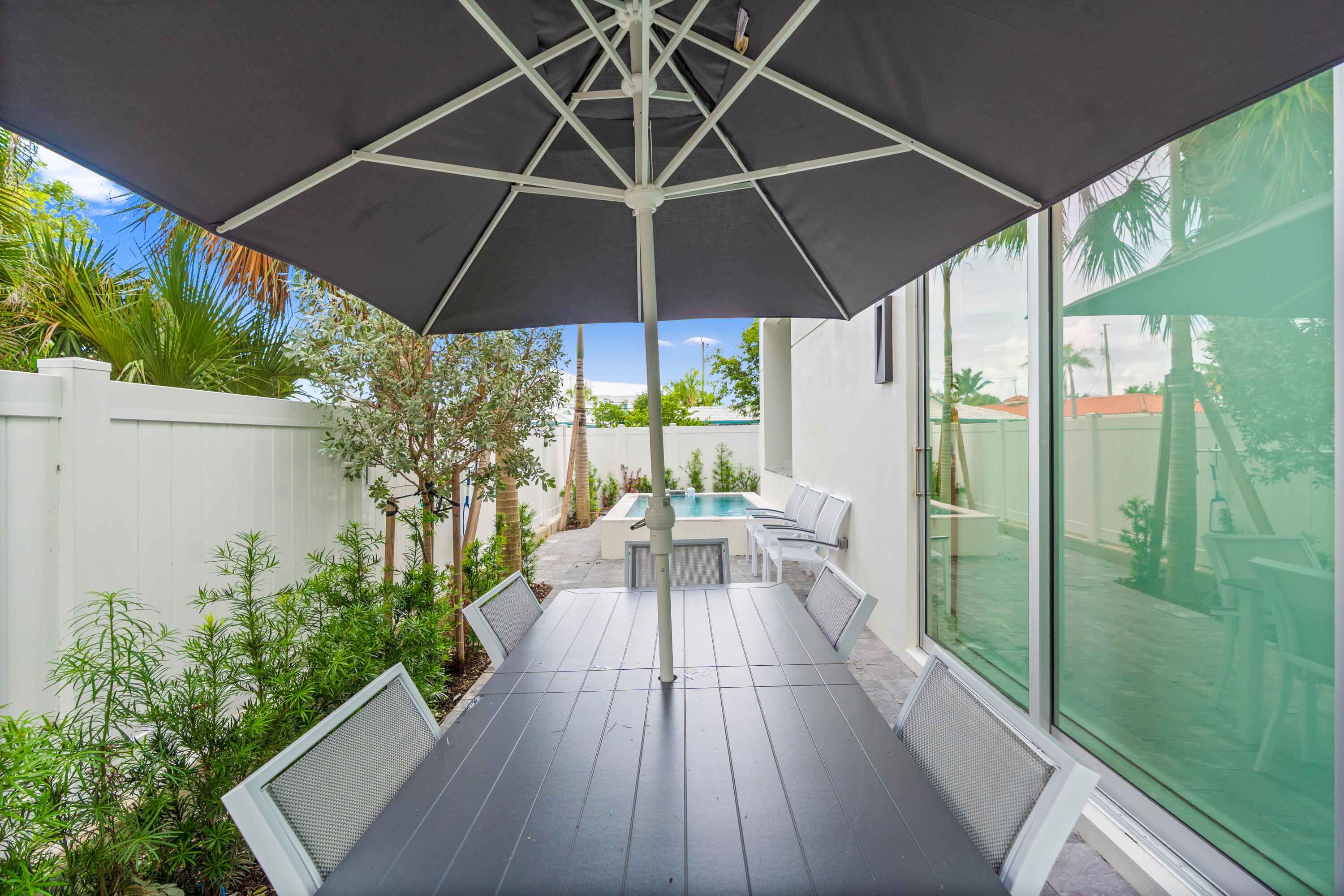 221 Shore Ct Patio Area Umbrella - A remarkable luxury townhome rental that redefines upscale living in the heart of Lauderdale By The Sea. This beautifully designed 3,027 sq. ft residence features 4 spacious beds & 4 baths, making it perfect for families or those who love to entertain. The home also offers an outdoor kitchen and BBQ area, along with a private plunge pool that invites relaxation and fun. For boating enthusiasts, a boat slip is also available for rent. Easy access to a plethora of amenities, beach, dining, & entertainment.
