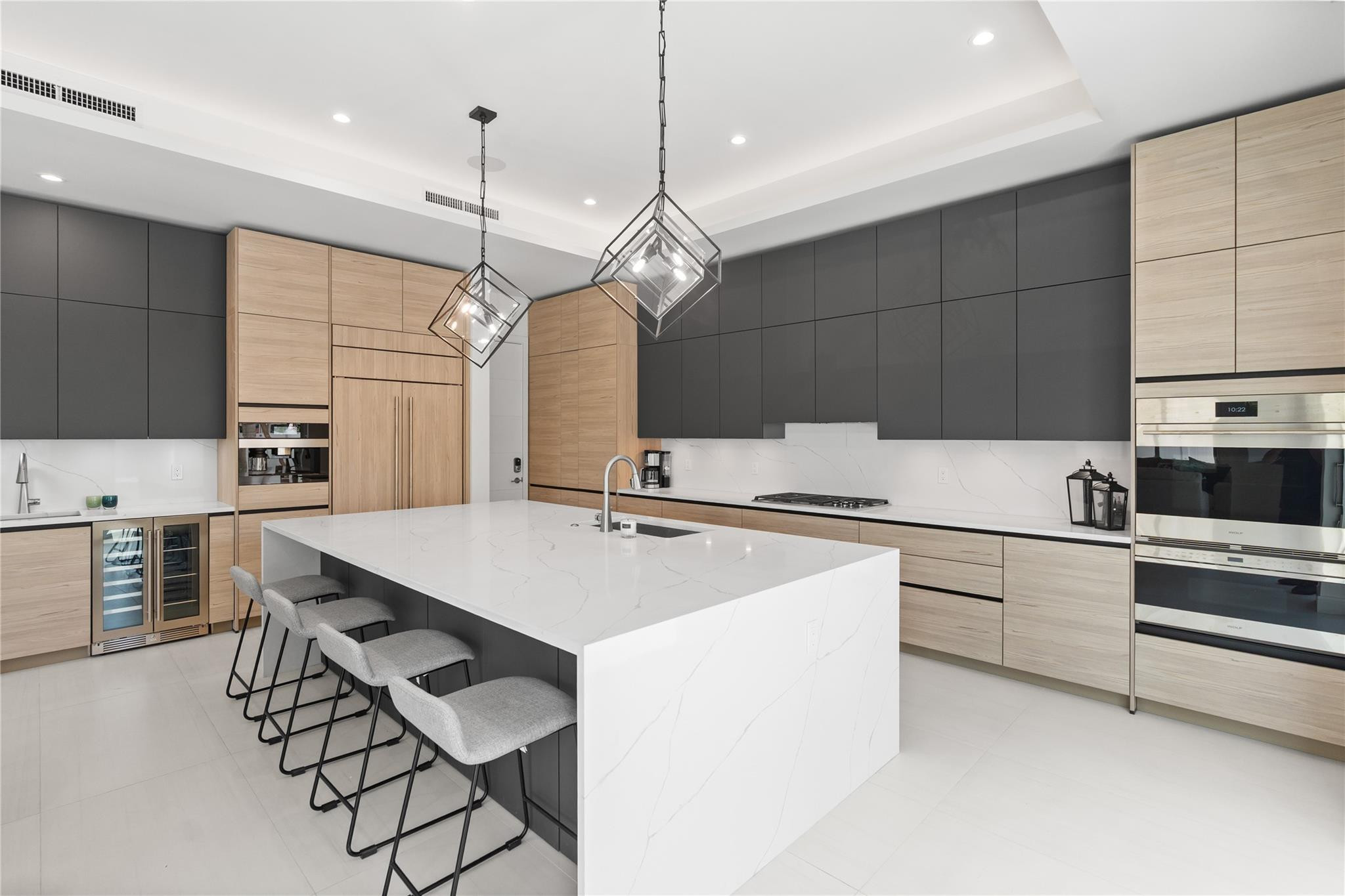 A custom designer kitchen with top of the line appliances, huge island, and tons of cabinetry storage. A remarkable luxury townhome rental that redefines upscale living in the heart of Lauderdale By The Sea. This beautifully designed 3,027 sq. ft residence features 4 spacious beds & 4 baths, making it perfect for families or those who love to entertain.The home also offers an outdoor kitchen and BBQ area, along with a private plunge pool that invites relaxation and fun. For boating enthusiasts, a boat slip is also available for rent. Easy access to a plethora of amenities, beach, dining, & entertainment.