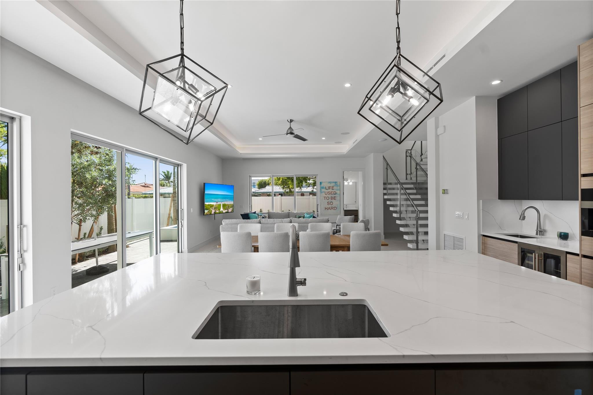 A custom designer kitchen with top of the line appliances, huge island, and tons of cabinetry storage. A remarkable luxury townhome rental that redefines upscale living in the heart of Lauderdale By The Sea. This beautifully designed 3,027 sq. ft residence features 4 spacious beds & 4 baths, making it perfect for families or those who love to entertain.The home also offers an outdoor kitchen and BBQ area, along with a private plunge pool that invites relaxation and fun. For boating enthusiasts, a boat slip is also available for rent. Easy access to a plethora of amenities, beach, dining, & entertainment.