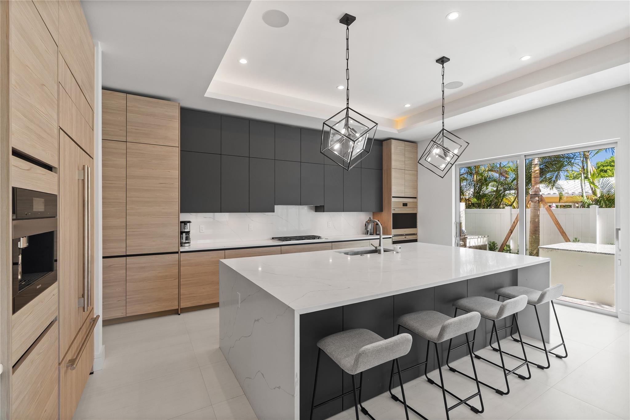 A custom designer kitchen with top of the line appliances, huge island, and tons of cabinetry storage. A remarkable luxury townhome rental that redefines upscale living in the heart of Lauderdale By The Sea. This beautifully designed 3,027 sq. ft residence features 4 spacious beds & 4 baths, making it perfect for families or those who love to entertain.The home also offers an outdoor kitchen and BBQ area, along with a private plunge pool that invites relaxation and fun. For boating enthusiasts, a boat slip is also available for rent. Easy access to a plethora of amenities, beach, dining, & entertainment.