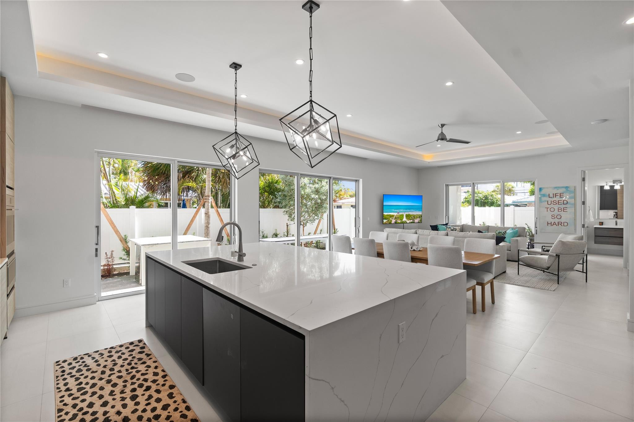 Open concept living area and kitchen - A remarkable luxury townhome rental that redefines upscale living in the heart of Lauderdale By The Sea. This beautifully designed 3,027 sq. ft residence features 4 spacious beds & 4 baths, making it perfect for families or those who love to entertain.The home also offers an outdoor kitchen and BBQ area, along with a private plunge pool that invites relaxation and fun. For boating enthusiasts, a boat slip is also available for rent. Easy access to a plethora of amenities, beach, dining, & entertainment.