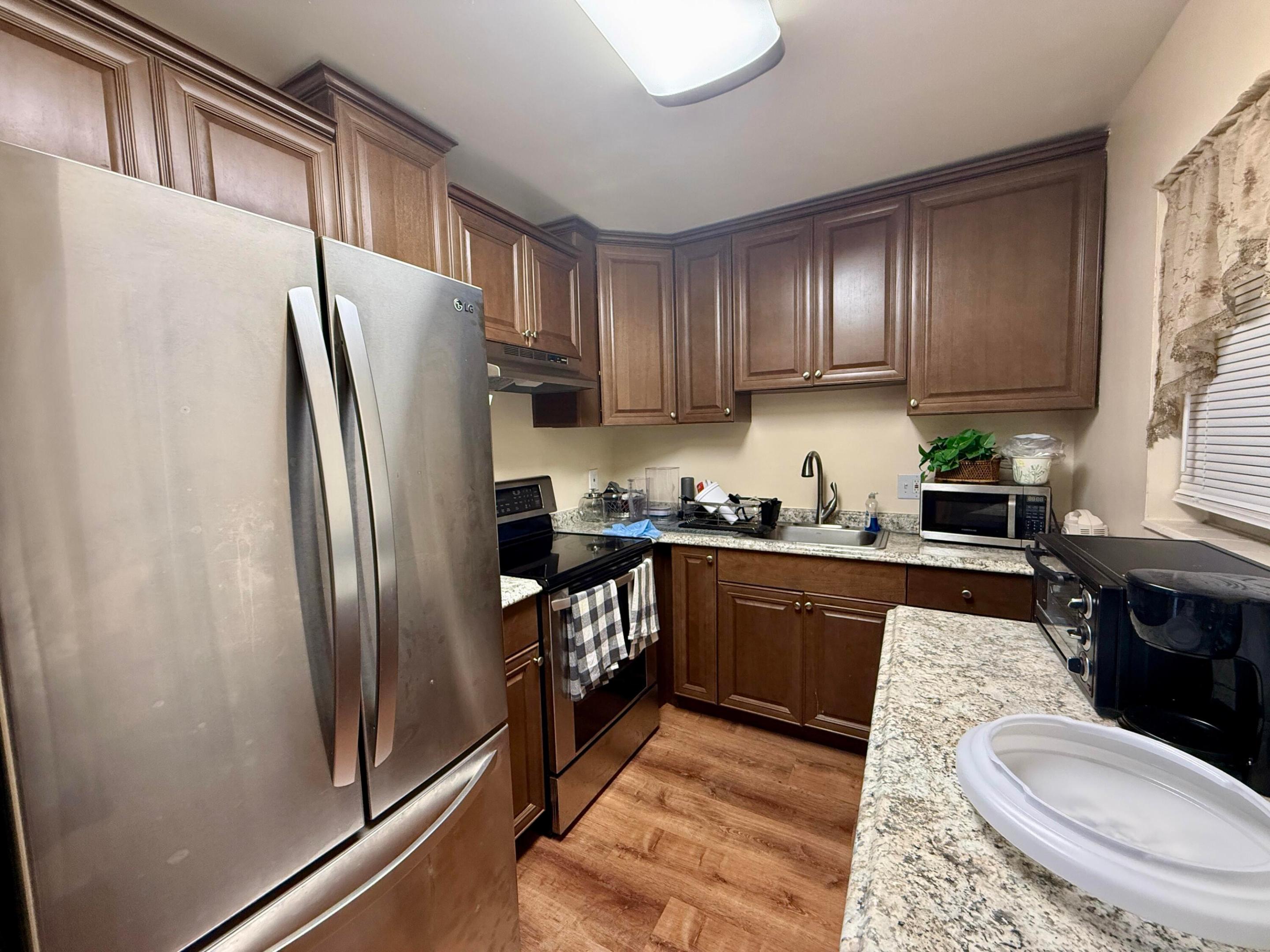 Pretty Updated Kitchen With Rich Wood Tone Cabinets, Stainless Appliances, and Window for Natural Light! Pretty Updated Kitchen With Rich Wood Tone Cabinets, Stainless Appliances, and Window for Natural Light!