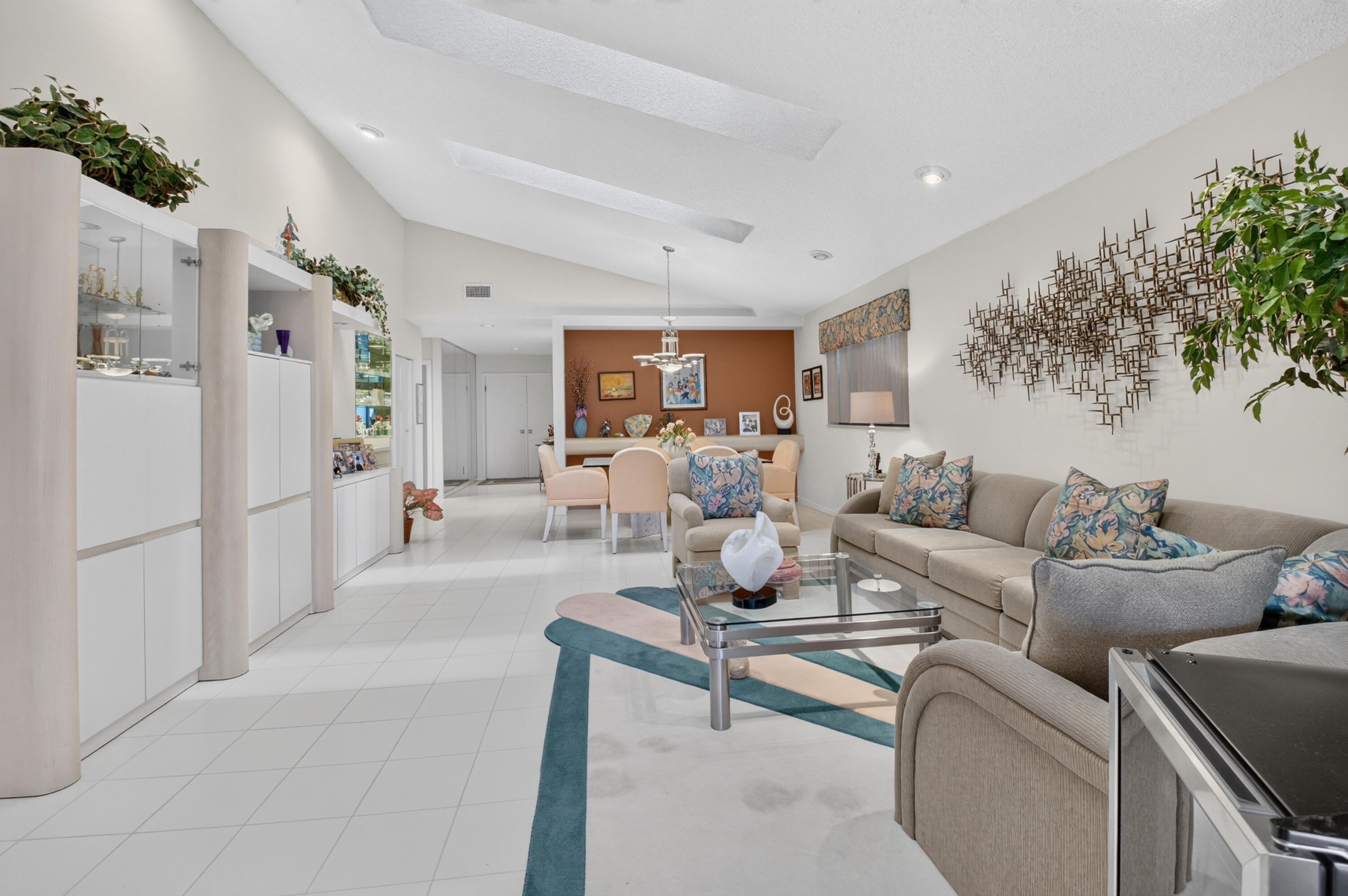 Vaulted ceilings with skylights, extensive built-in cabinetry, tile flooring, recessed lighting, and a defined dining area