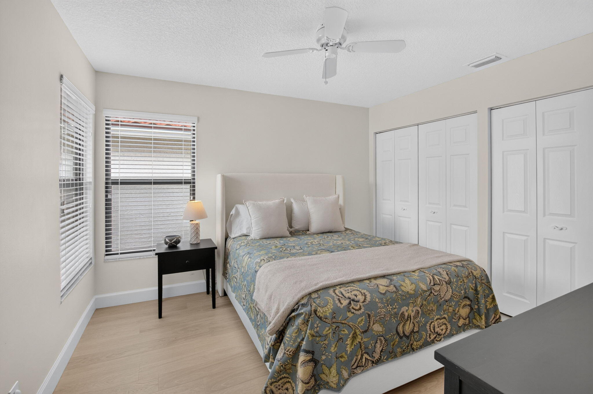 SUNNY GUEST BEDROOM WITH DUAL CLOSETS