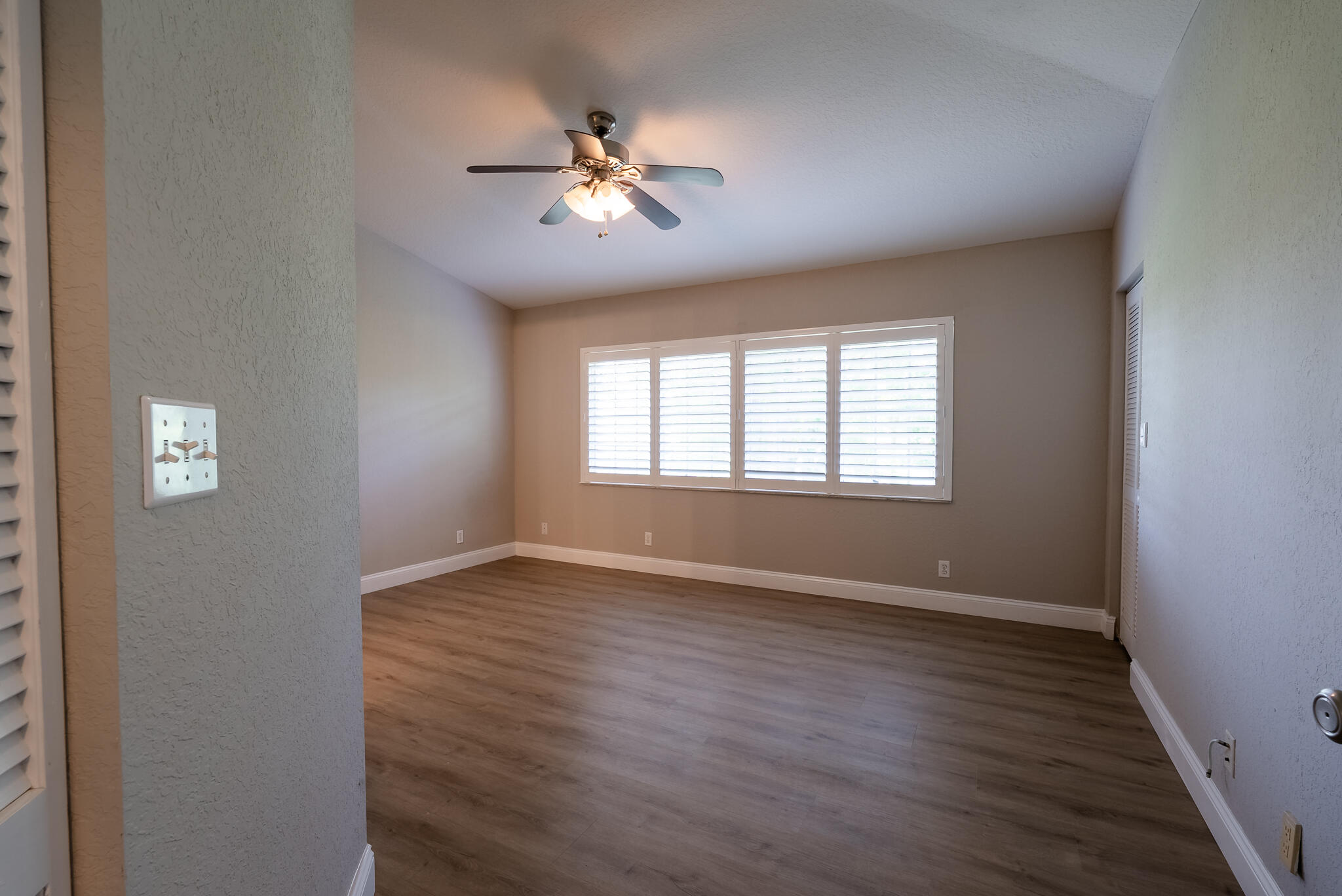 PRIMARY BEDROOM WITH PLANTATION SHUTTERS