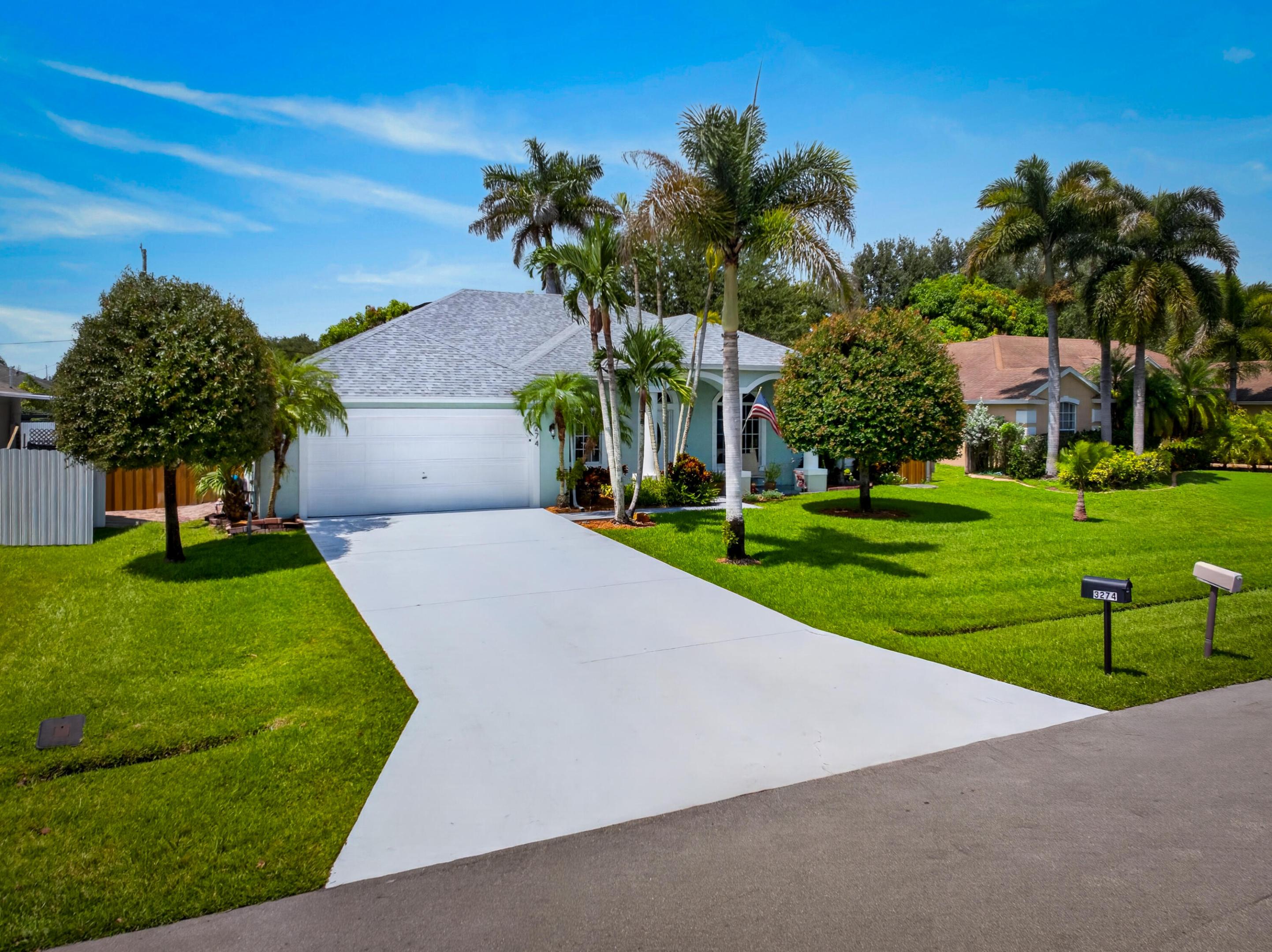 Single-story residence featuring a two-car garage, concrete driveway, and a shingle roof