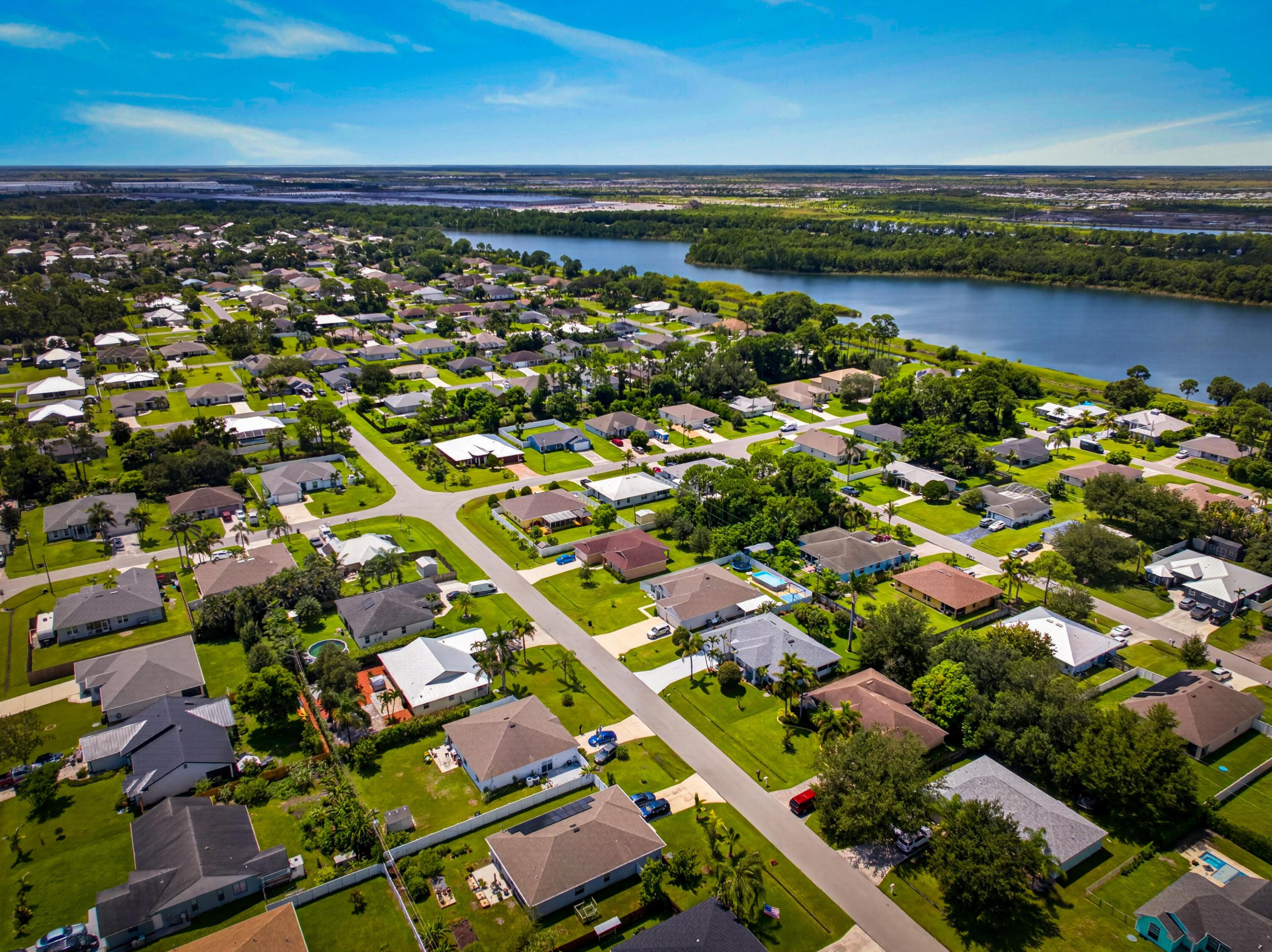 Residential community featuring single-story homes, mature landscaping, and paved streets