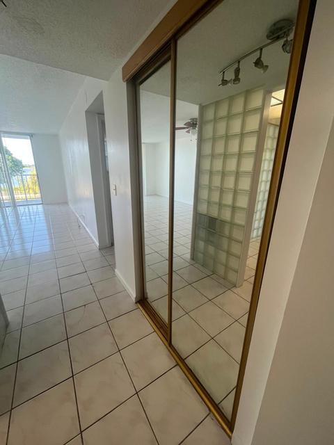 Mirrored sliding closet doors, ceiling-mounted track lighting, and a glass block wall feature