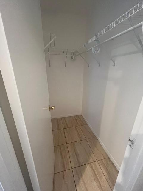 Closet featuring tile flooring, white walls, and built-in wire shelving