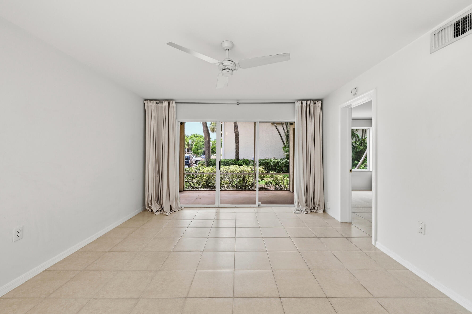 Living area with tile flooring and a ceiling fan