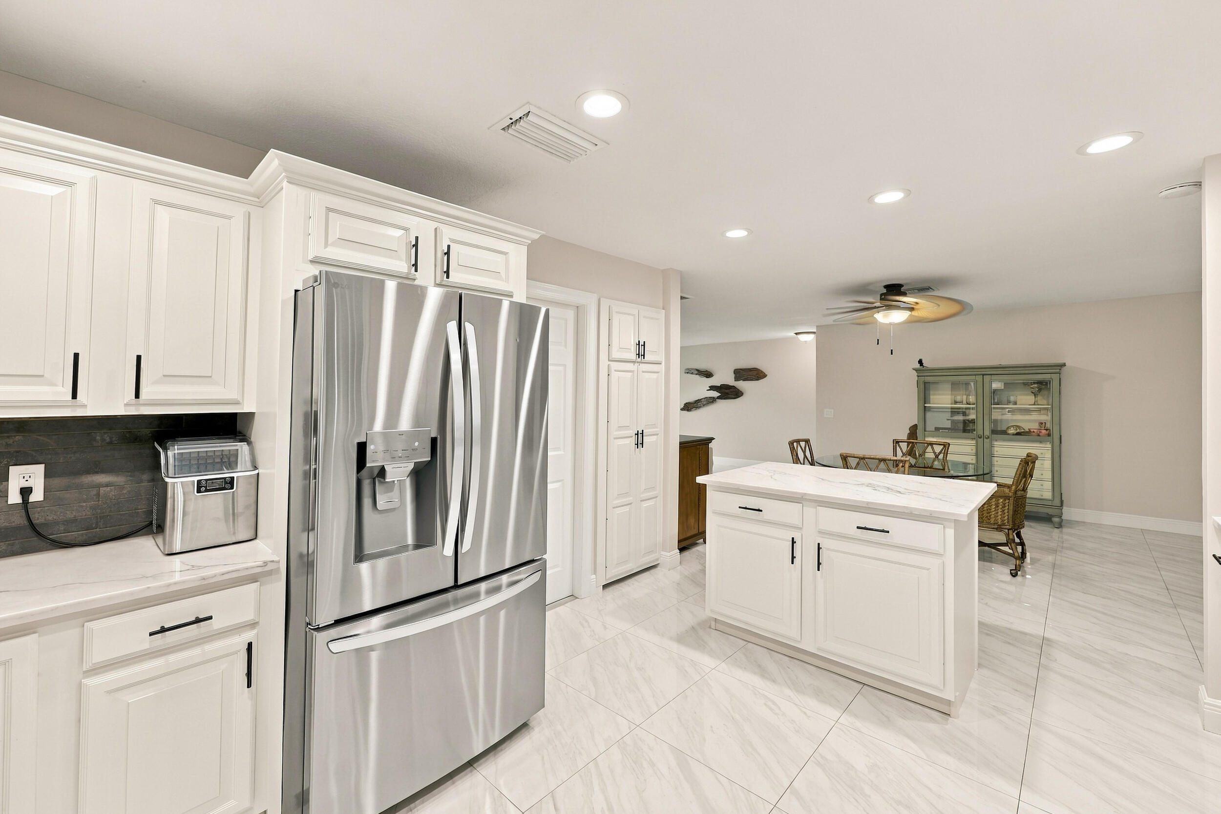 The impeccably upgraded kitchen offers white cabinetry, quartz countertops, stainless steel appliances, and a beautiful charcoal backsplash. There is tons of storage and counter space for even the most discerning chef.