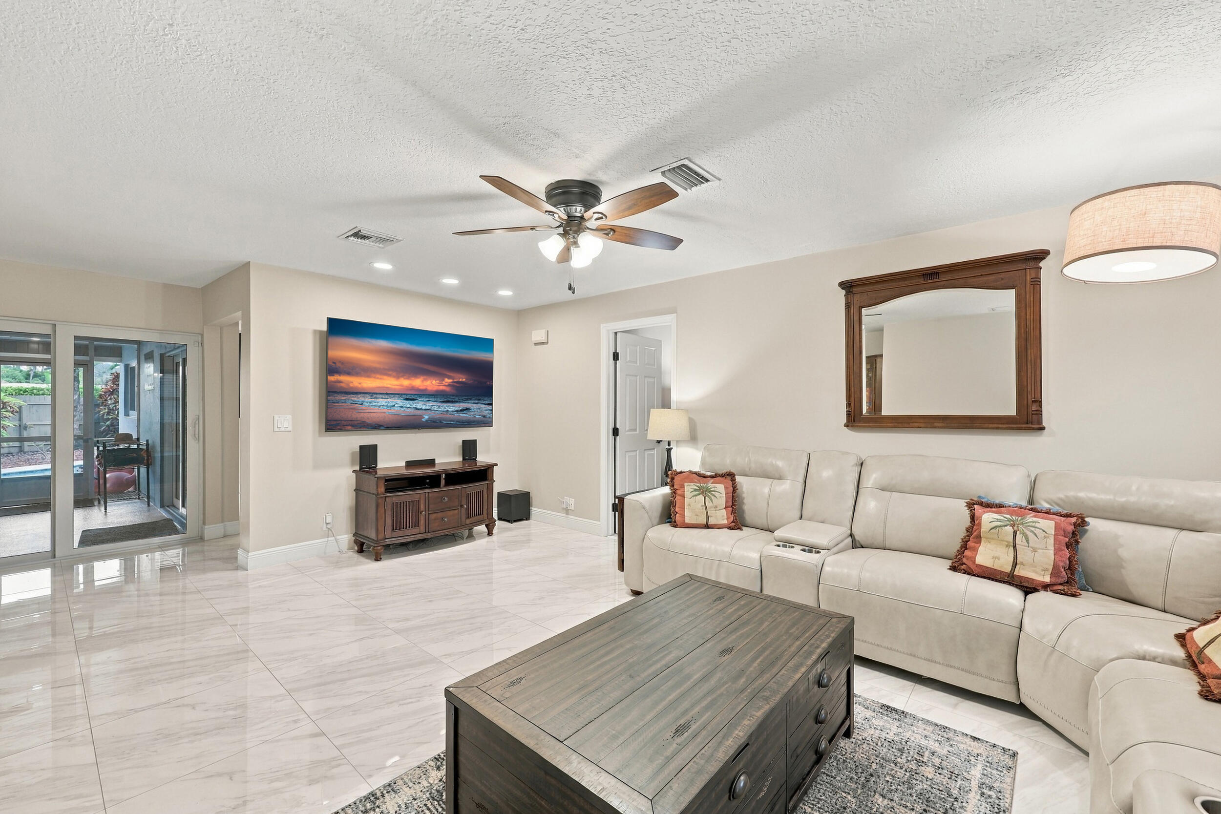 The family room is a versatile space for children of all ages. Relax and enjoy a separate area away from the kitchen and formal living room that also provides direct access through sliding glass doors to the covered patio and one-of-a-kind backyard.
