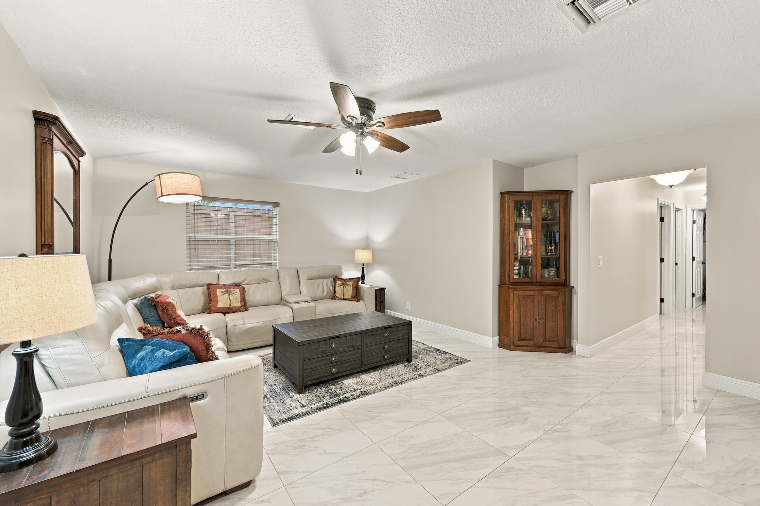 The family room is a versatile space for children of all ages. Relax and enjoy a separate area away from the kitchen and formal living room that also provides direct access through sliding glass doors to the covered patio and one-of-a-kind backyard. Down the hallway are three guest bedrooms and two full bathrooms.