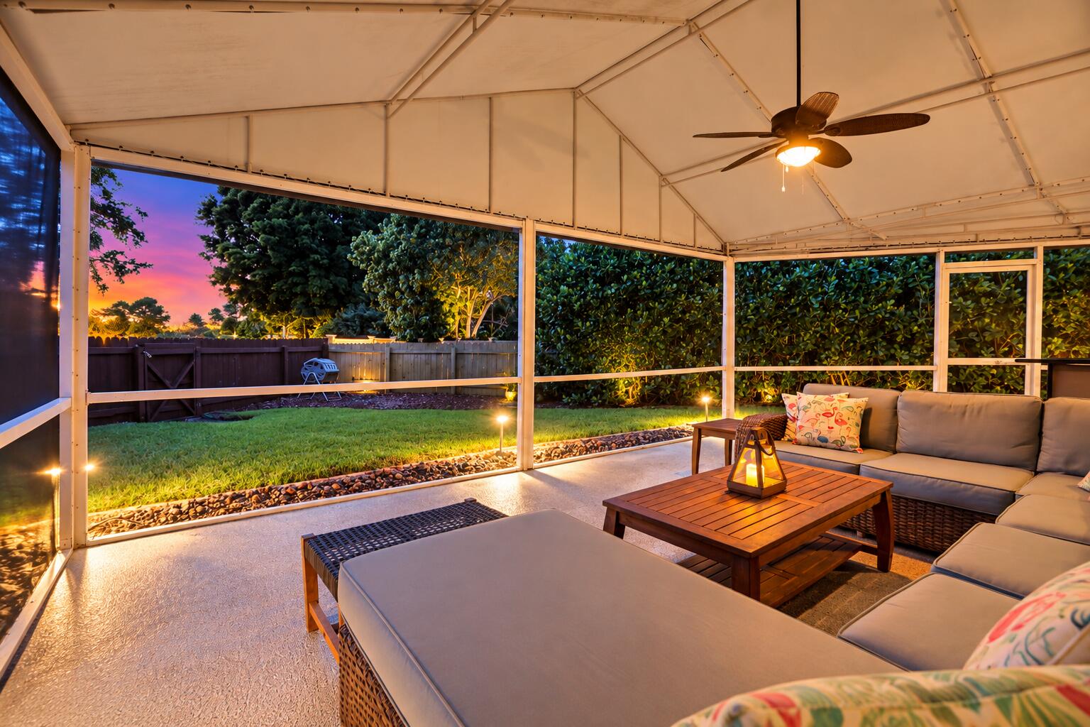 A living room outside is highlighted by vaulted ceilings, a privacy fence, views of Lakeview Golf Course, and a versatile area to entertain.