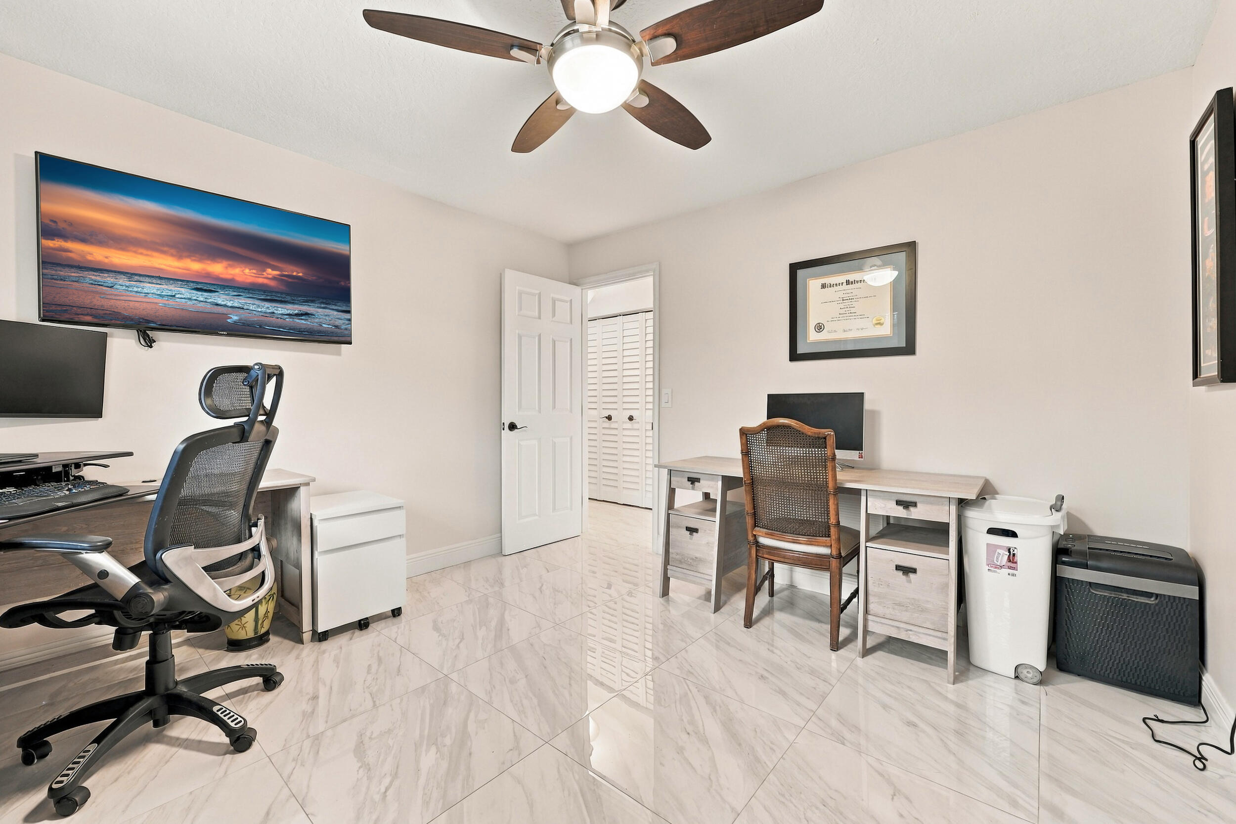 Guest bedroom 1 is spacious with large impact windows and ample closet space.