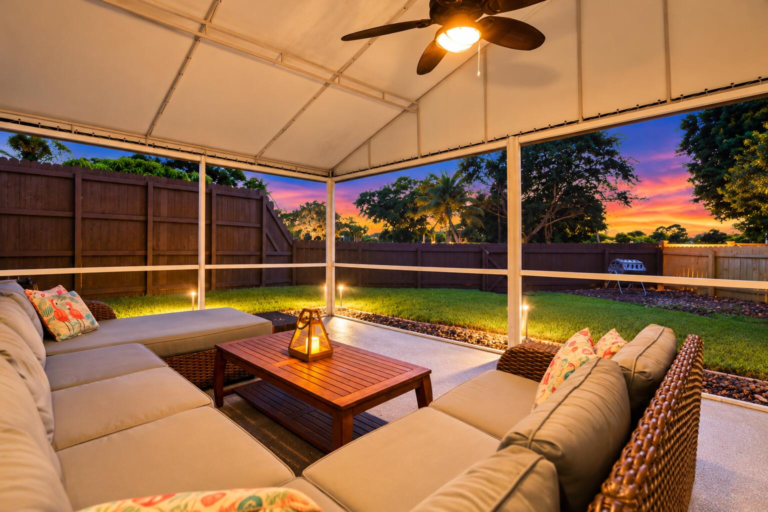 A living room outside is highlighted by vaulted ceilings, a privacy fence, views of Lakeview Golf Course, and a versatile area to entertain.