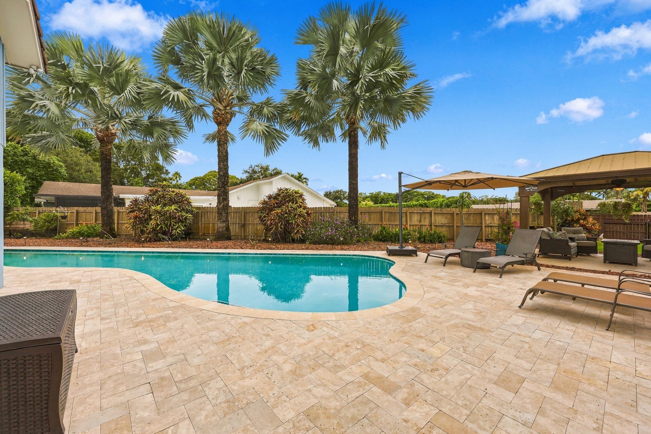 The resort-style pool starts underneath the roof line and expands down the oversized lot. Swim Olympic laps in your own backyard.