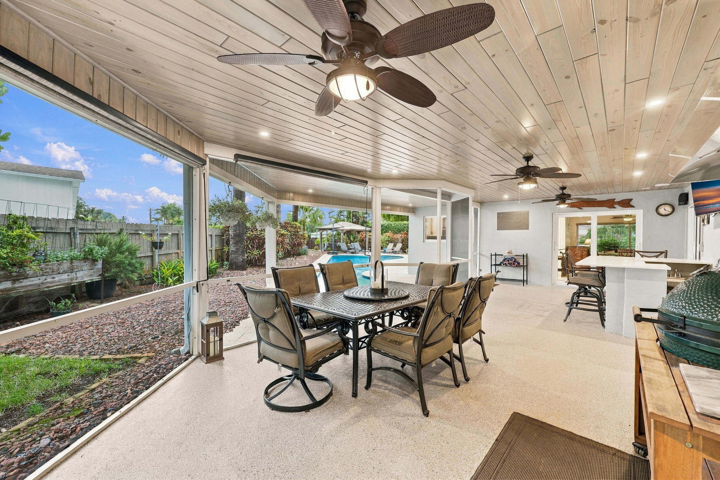 Live the epitome of the South Florida lifestyle with this 1,360 sq. ft. patio. It offers a built-in bar with quartz countertops, a grill area with hooded exhaust, eye-popping tongue & groove ceilings, recessed lights, tons of privacy and views of Lakeview Golf Course.