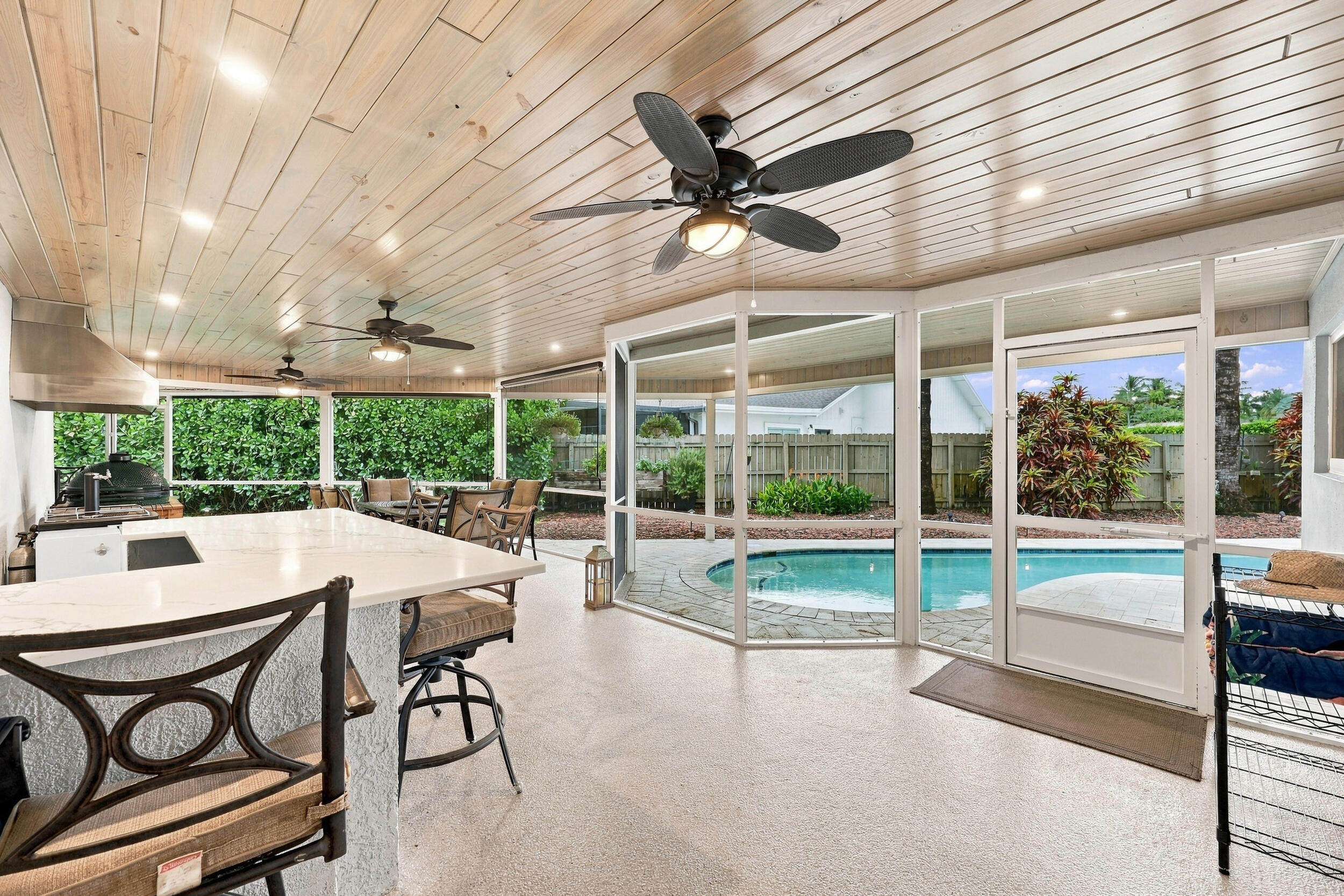 Live the epitome of the South Florida lifestyle with this 1,360 sq. ft. patio. It offers a built-in bar with quartz countertops, a grill area with hooded exhaust, eye-popping tongue & groove ceilings, recessed lights, tons of privacy and views of Lakeview Golf Course.
