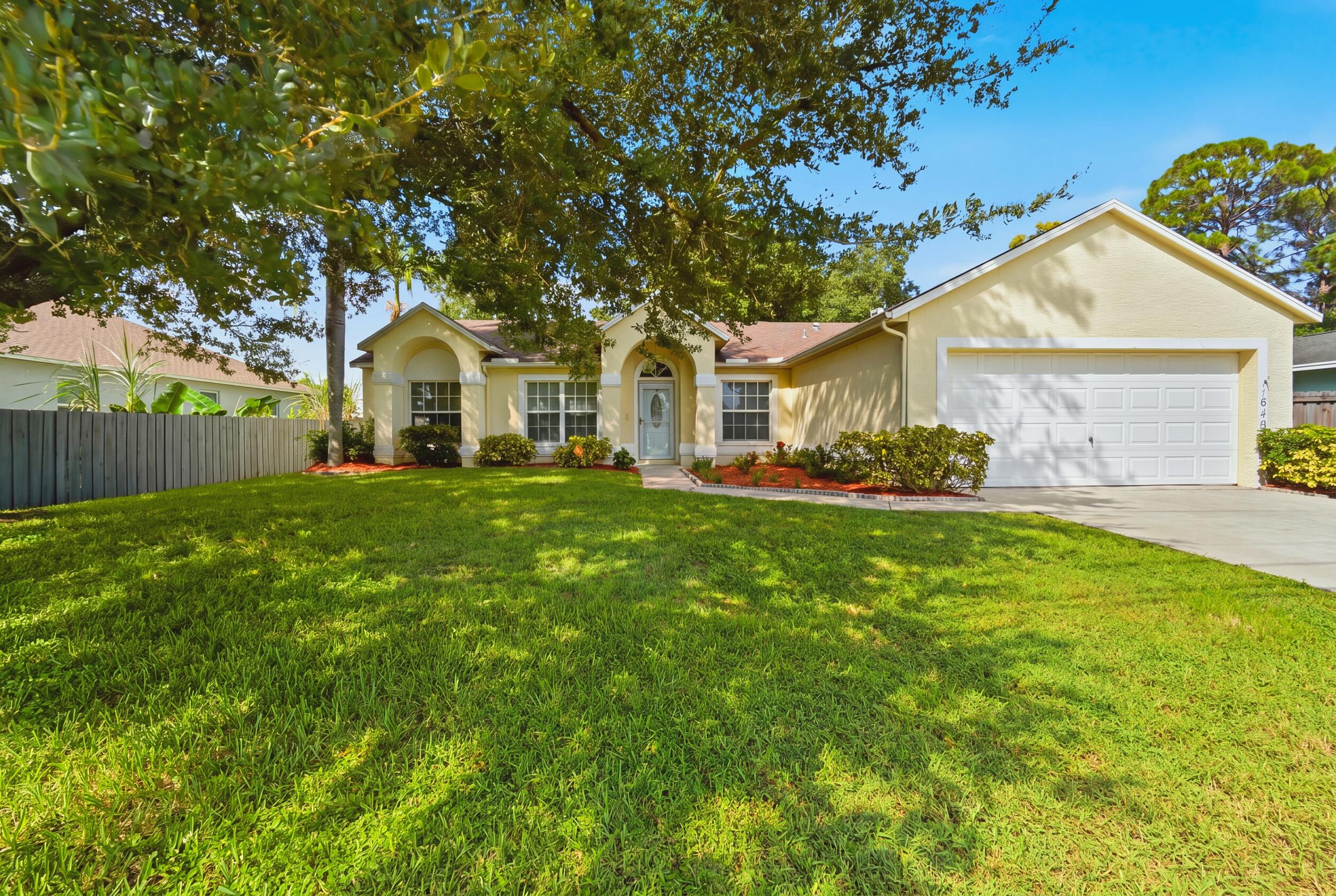 Single-story residence featuring a stucco exterior, arched covered entryway, multi-pane windows, and an attached two-car garage Single-story residence featuring a stucco exterior, arched covered entryway, multi-pane windows, and an attached two-car garage
